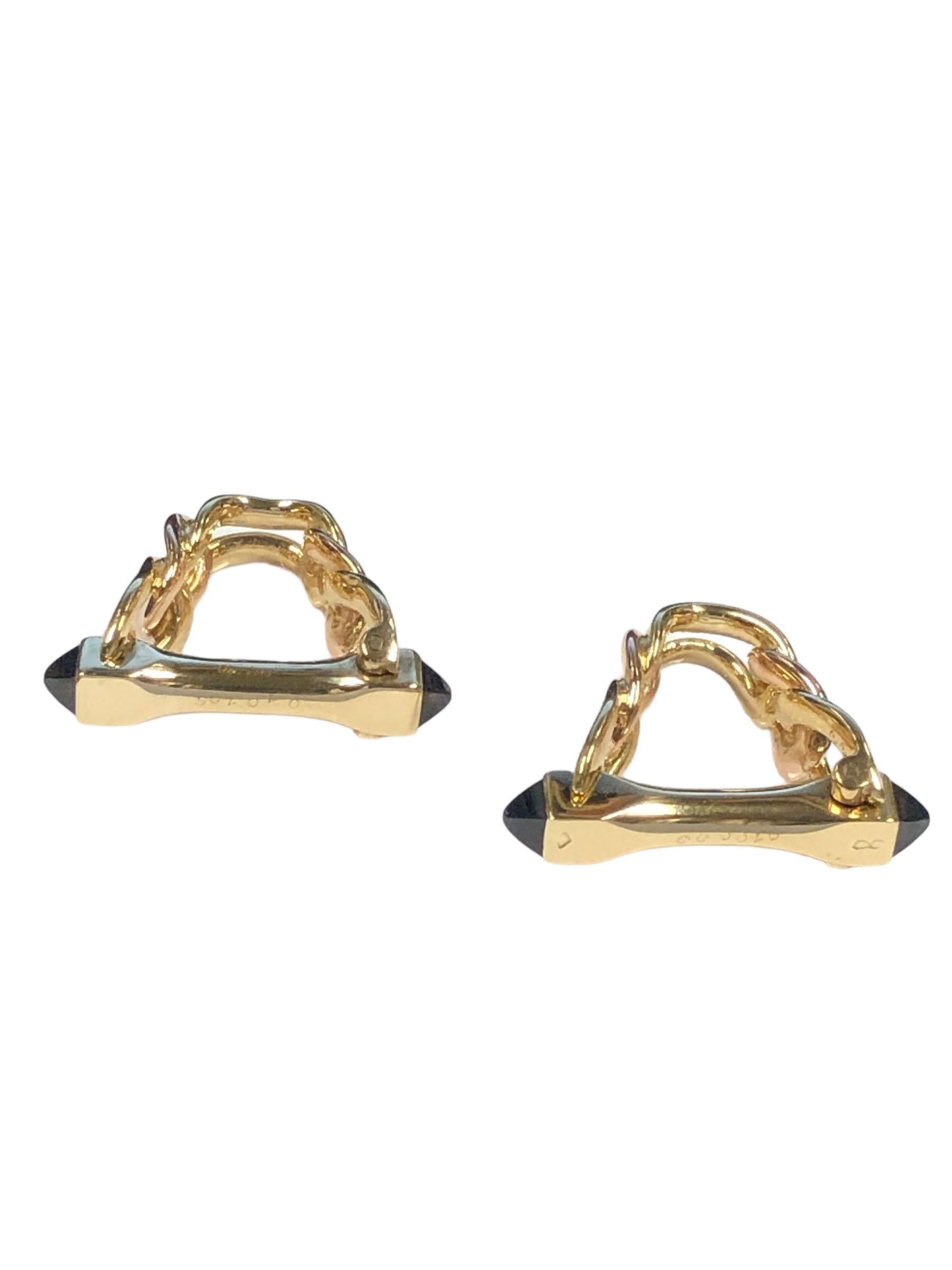 Circa 1960 - 1970 Cartier Paris 18k Yellow Gold Stirrup Cufflinks. measuring 1 inch in length X 1 inch, having a solid link design and set with Pyramid shape Cabochon Sapphires, Signed and Numbered. These are well designed for easy self on and off. 