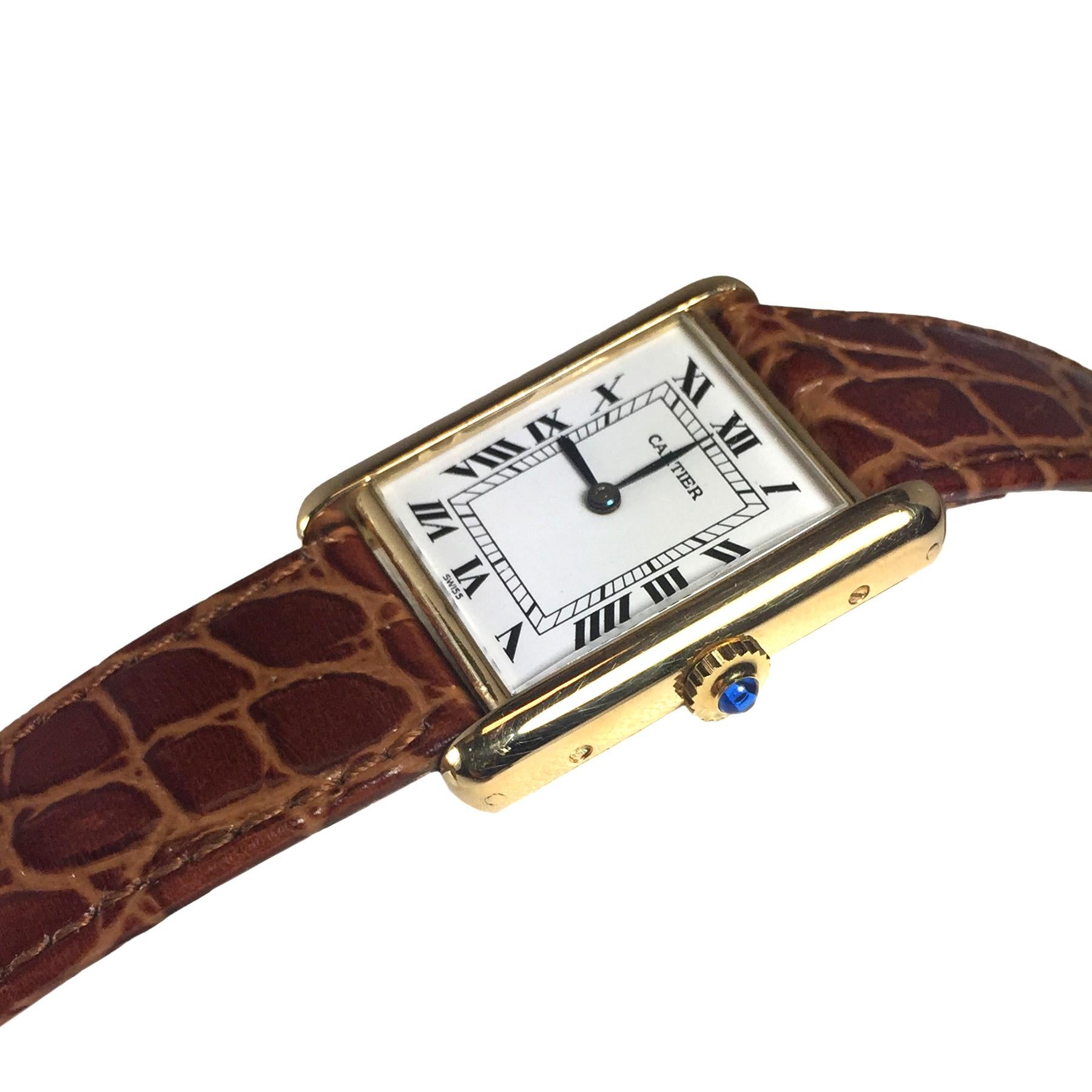 Circa 1980s Cartier Paris Tank Wrist watch, 30 X 23 MM 18K Yellow Gold Case, Mechanical, Manual wind 17 Jewel Cartier Movement, White Dial with Black Roman Numerals, Sapphire Crown. Hirsch Brown Croco Strap with Cartier Gold Plate Tang Buckle. Watch