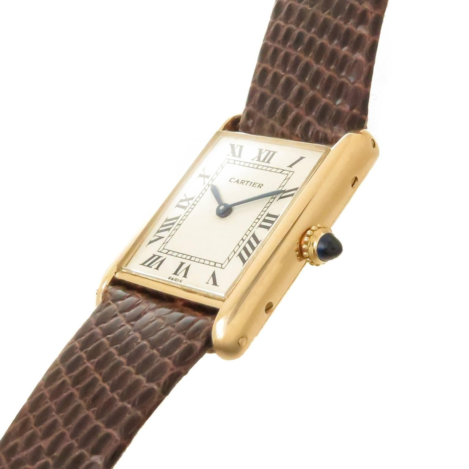 Circa 1980s Cartier Paris Tank Wrist watch, 30 X 23 MM 18K Yellow Gold Case, Mechanical, Manual wind 17 Jewel cartier Movement, White Dial with Black Roman Numerals, Sapphire Crown. New Brown Lizard Strap with Cartier Gold Plate Tang Buckle. Watch