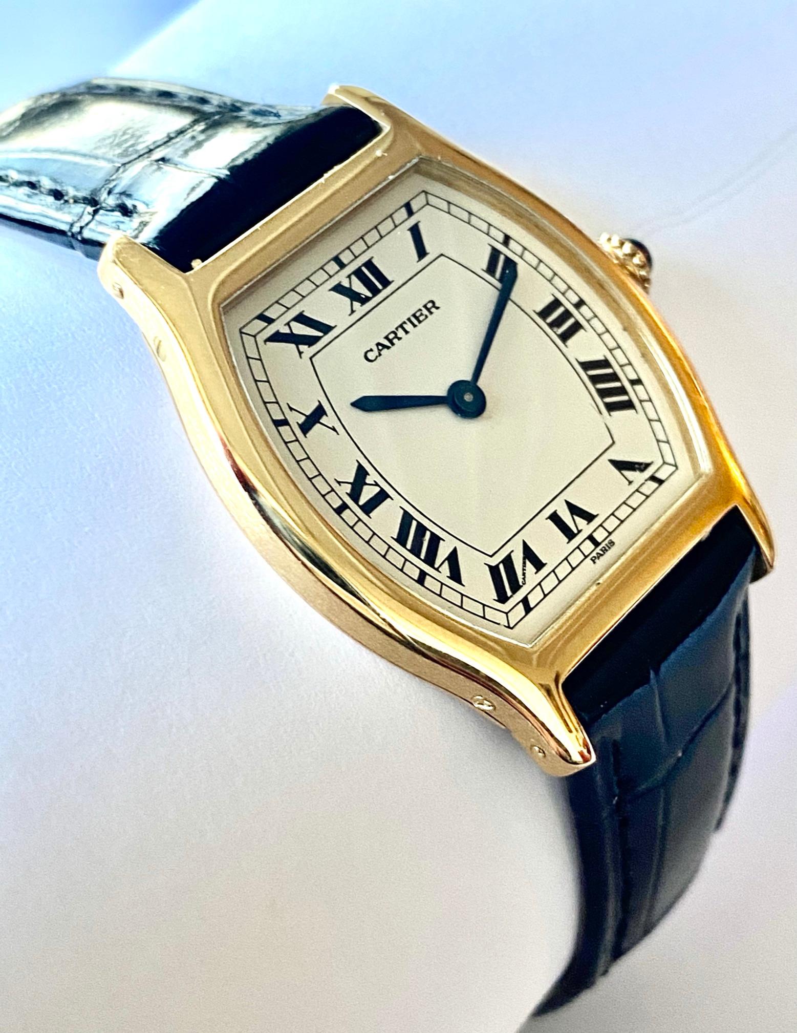 One (1) 18K. Yellow Gold Watch with a leather strap
Brand: Cartier    Paris     ca 1975
Model: Tortue  extra flat   Model nr 96069   nr 45!
Mouvement: Piquet nr 21 extra flat handwinding  mouvemnet nr 14613
Leather Cartier Kroko strap with original