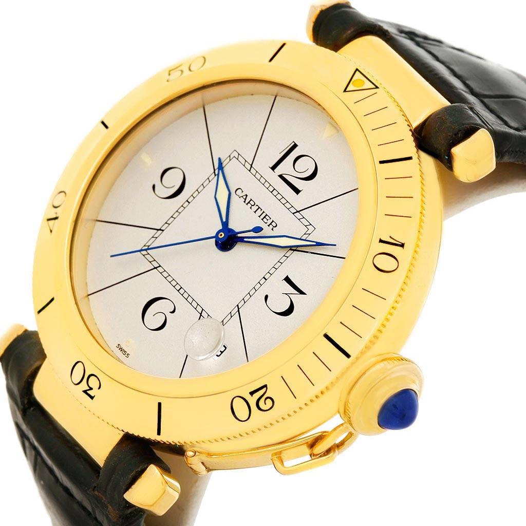 Cartier Pasha 38mm 18K Yellow Gold Automatic Mens Watch. Automatic self-winding movement. Round 18K yellow gold case 38.0 mm in diameter. Crown cover with blue sapphire cabochon. Scratch resistant sapphire crystal. Silvered dial wth arabic numerals