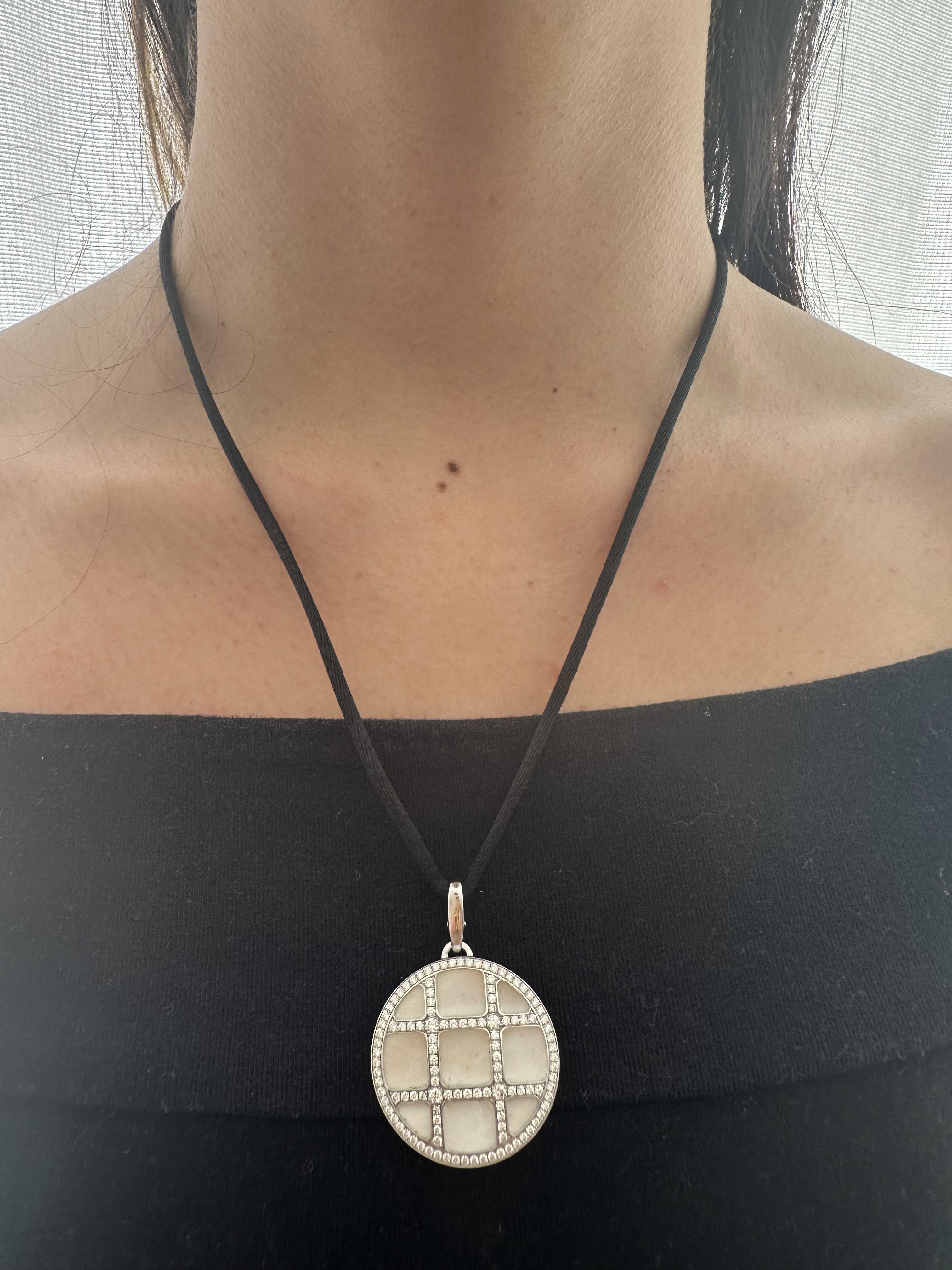This beautiful pendant from Cartier's Pasha collection is absolutely impressive The pendant is made of 18K white gold and is accented with mother of pearl and paved with white Diamonds approx. 0.70 Carats. F-G color, VS clarity. Includes original