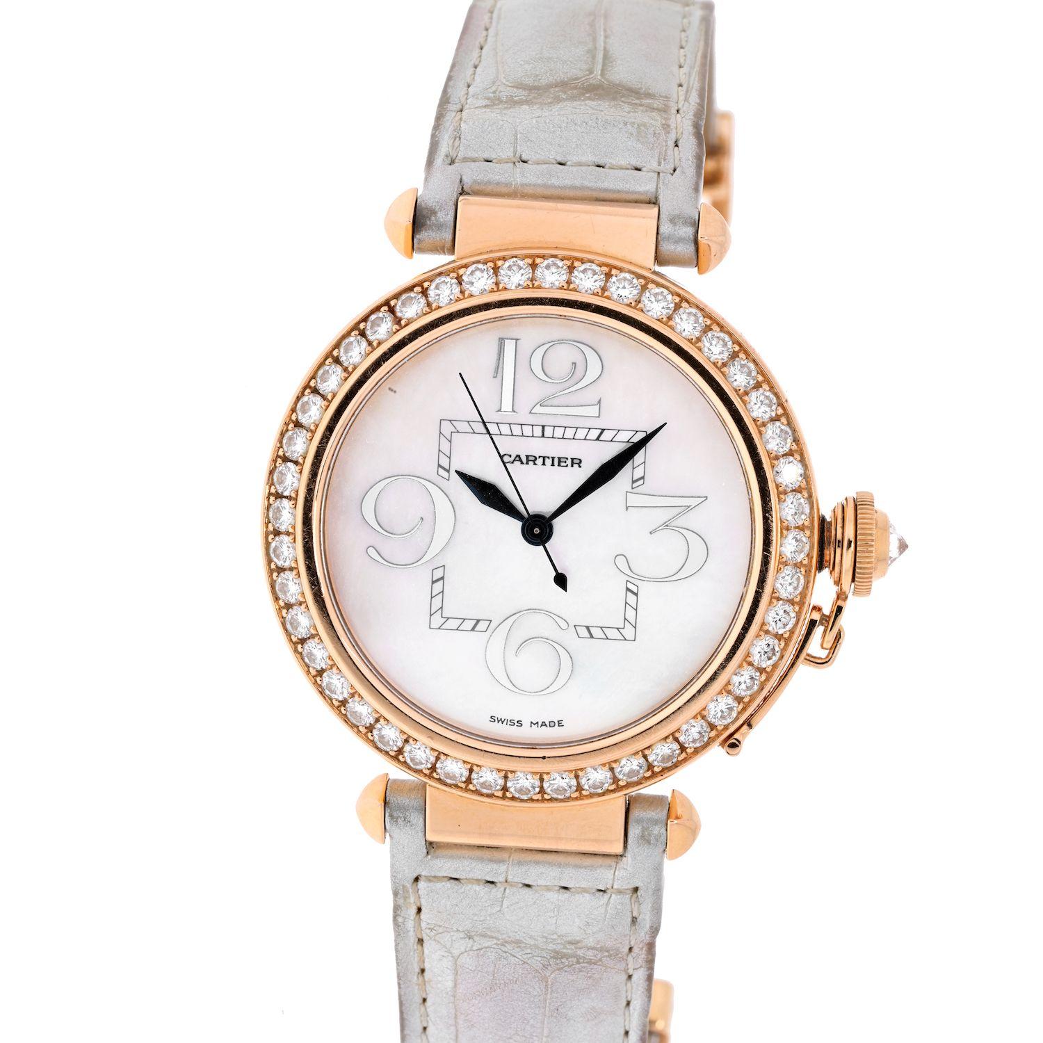 Cartier Pasha 18K Rose Gold Ladies Diamond Round White Dial 42mm Ladies Watch on a white leather strap. 
This watch is pre-owned but works perfect. Diamonds on the bezel are al loriginal. Crystal and sapphire show no signs of wear. 
Dial measures