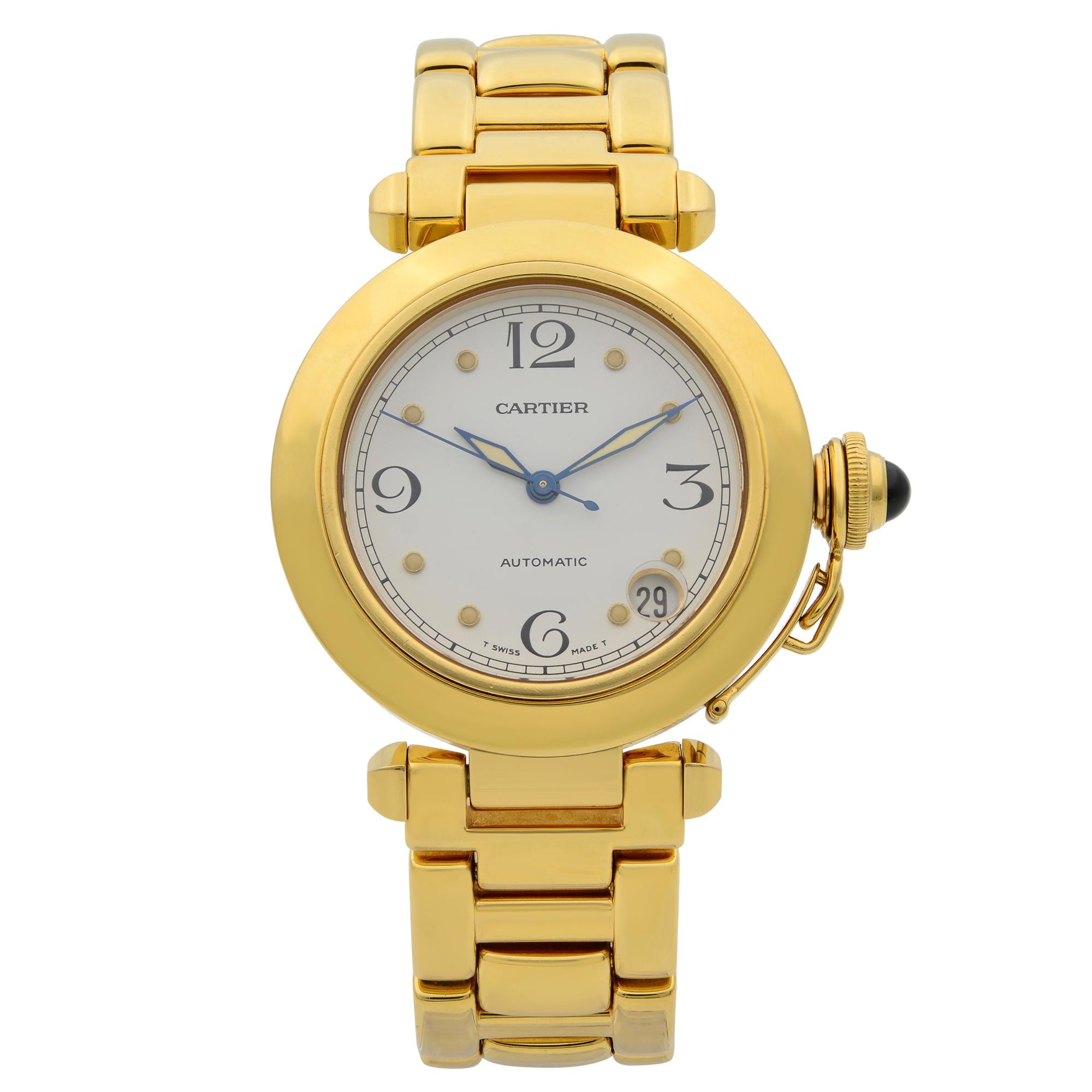 This pre-owned Cartier Pasha  WJ1110H9 is a beautiful Ladie's timepiece that is powered by mechanical (automatic) movement which is cased in a yellow gold case. It has a round shape face, date indicator dial and has hand arabic numerals, dots style