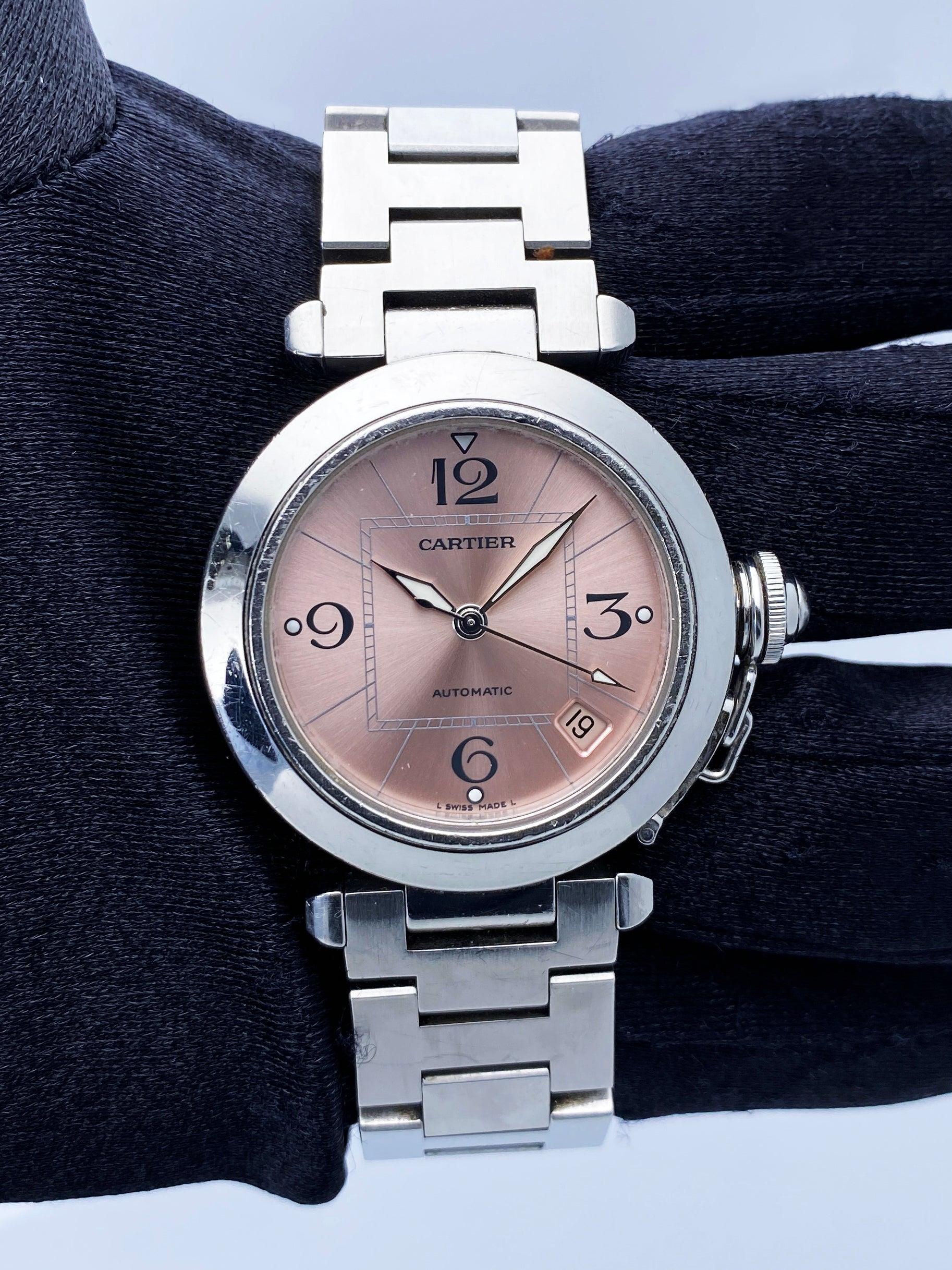 Cartier Pasha 2324 Ladies Watch. 36mm stainless steel case with stainless steel smooth bezel. Pink dial with blue hands and Arabic numeral hour markers. Minute markers on the inner dial. Date display between 4 and 5 o'clock position. Stainless steel