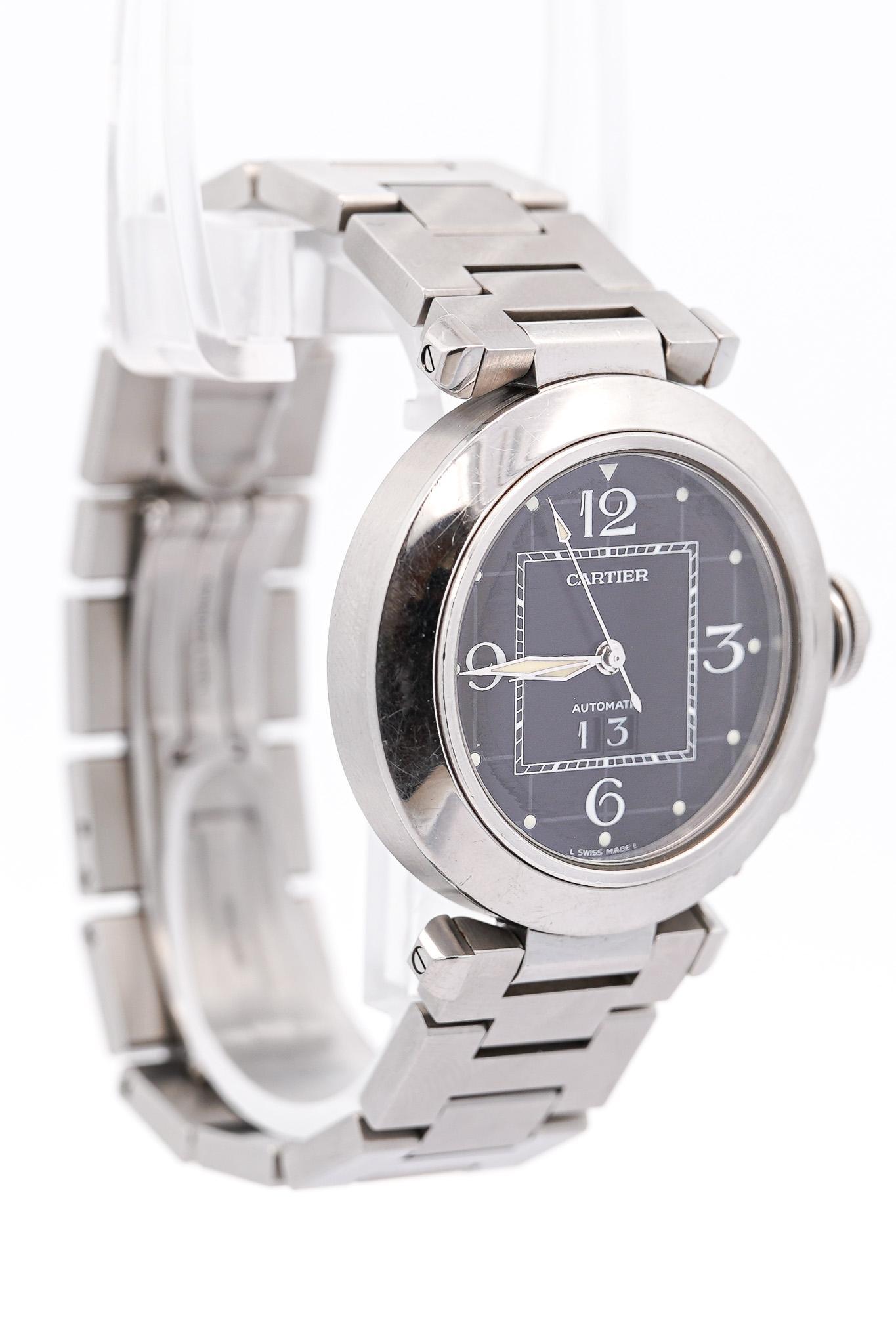 Cartier Pasha 2475 Black Dial Automatic 35mm Watch With Box and Service Papers.

- Brand: Cartier
- Condition: Pre-Owned (Excellent)
- Model: Pasha 
- Reference No.: 2475
- Case Diameter: 35mm
- Wrist Size: Fits up to 6.5