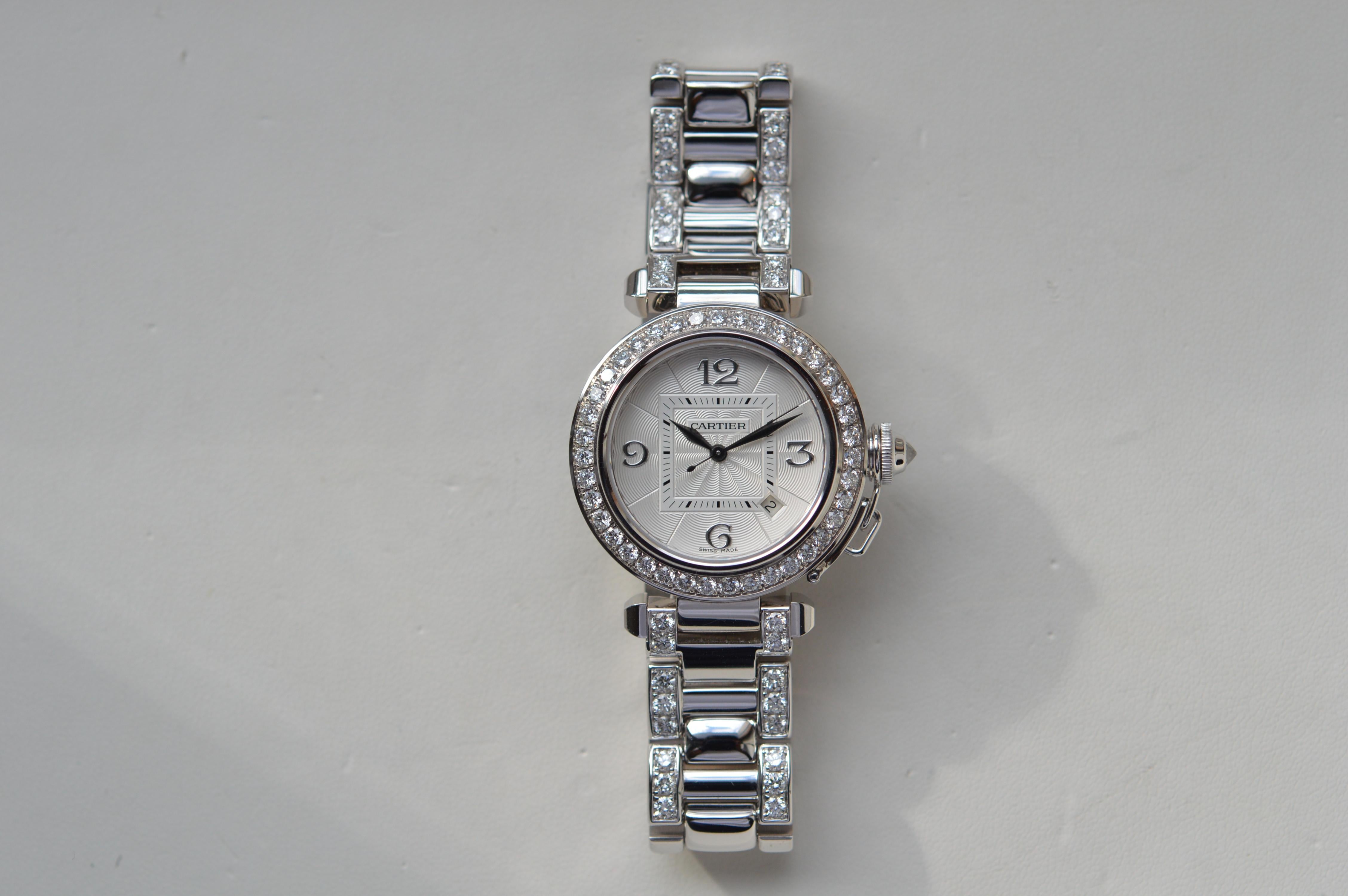 Cartier Pasha 32mm Pavé Bezel and Bracelet end Link
Reference n° WJ1116LK
32mm Size
18K White Gold
Open Back case
Automatic Movement
Original Cartier Diamond Settings
Set with a total of 132 Diamonds for a weight of 6.61 carats
Case & Crown 1.81