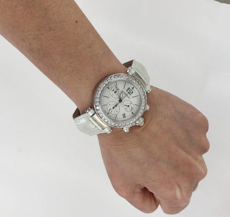 Cartier White Gold Pasha 37mm Seatimer Diamond Chronograph Watch in 18k White Gold.

A classic chronograph Pasha® de Cartier watch featuring a mother-of-pearl face surrounded by one row of white diamond pave mounted in 18k white gold. Includes a