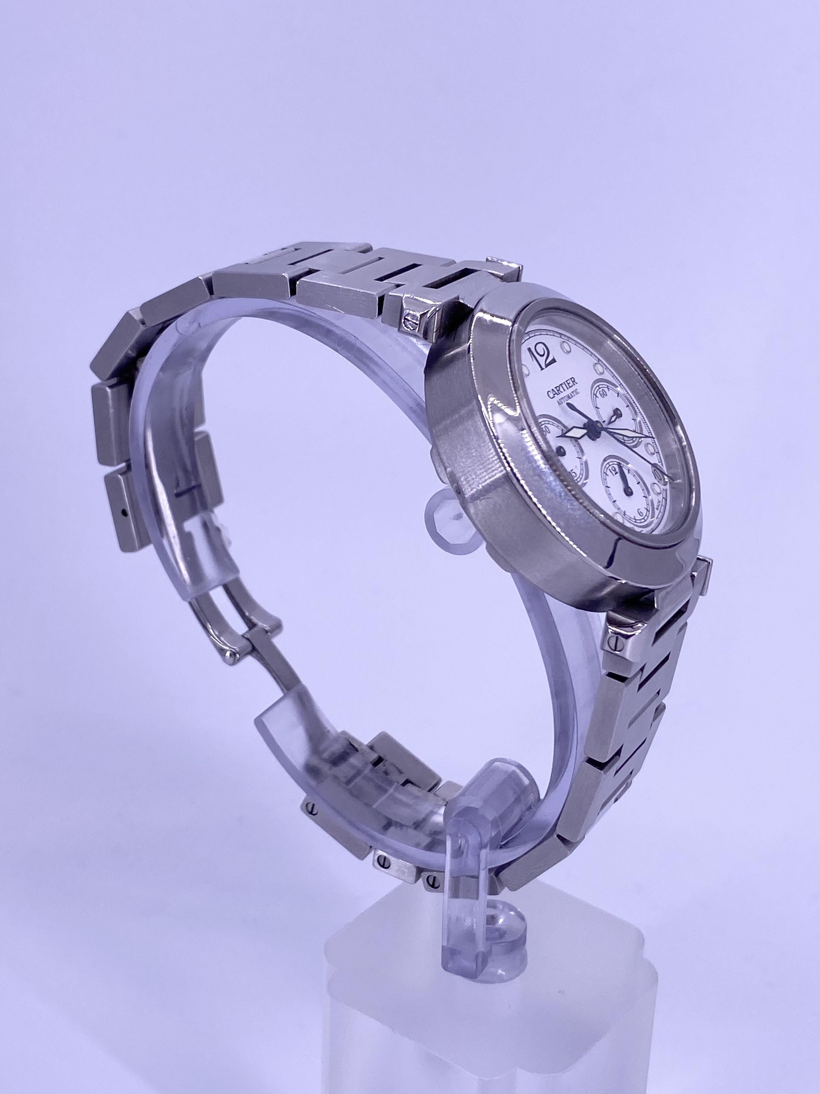 BRAND: Cartier
MODEL: Pasha Chronograph
REFRENCE: 2412
SIZE: 36mm
CASE: Stainless Steel
DIAL: White
BAND: Stainless Steen
WRIST SIZE: 6.75
MOVEMENT: Automatic

No box or papers.

Accommodated with an up to date digital appraisal by a GIA G.G., once