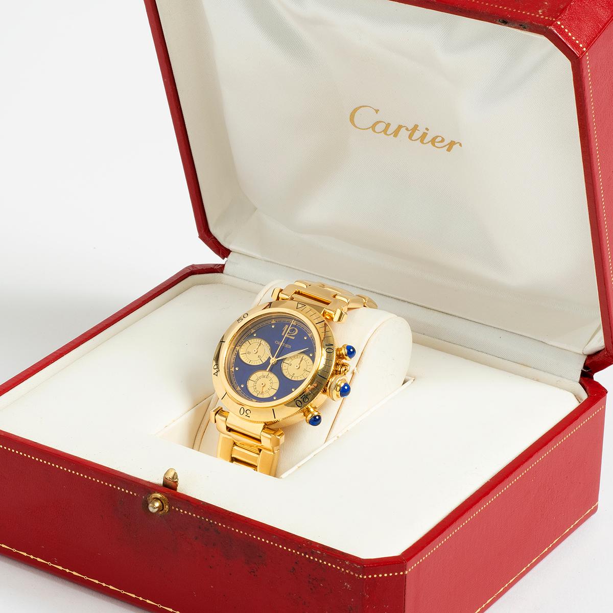 Our extremely rare Cartier Pasha chronograph quartz with date and rotating bezel, features an 18k yellow gold case and 18k yellow gold bracelet (featuring a safety clasp), with gold/ blue dial. A prominent and iconic 1980s/ 1990s Cartier design,