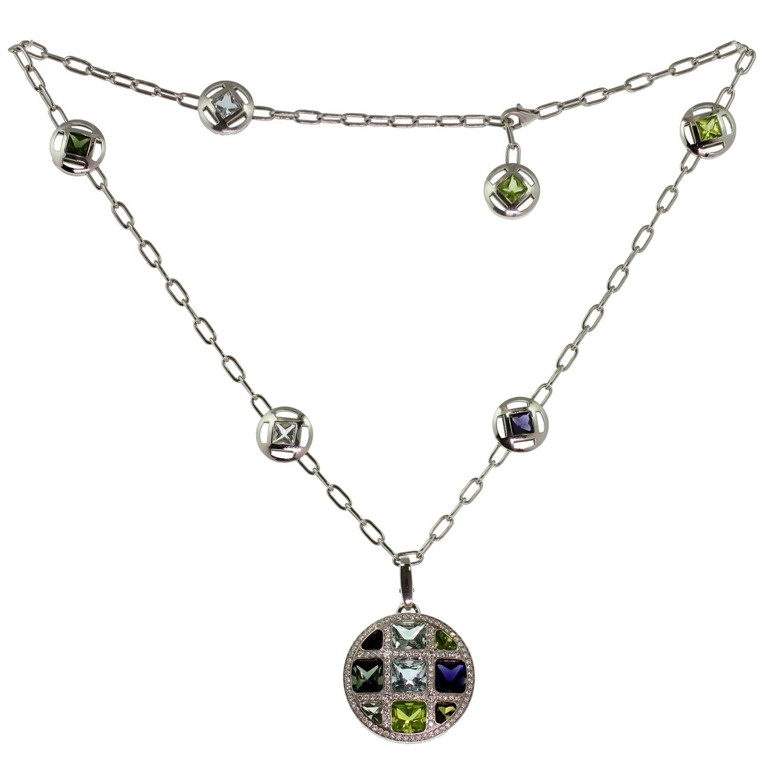 This rare Cartier necklace and enhancer pendant from the fabulous Pasha collection is crafted in 18k white gold and set with round brilliant-cut diamonds and a vibrant array of gemstones: aquamarine, iolite, peridot, and tourmaline. Made in France