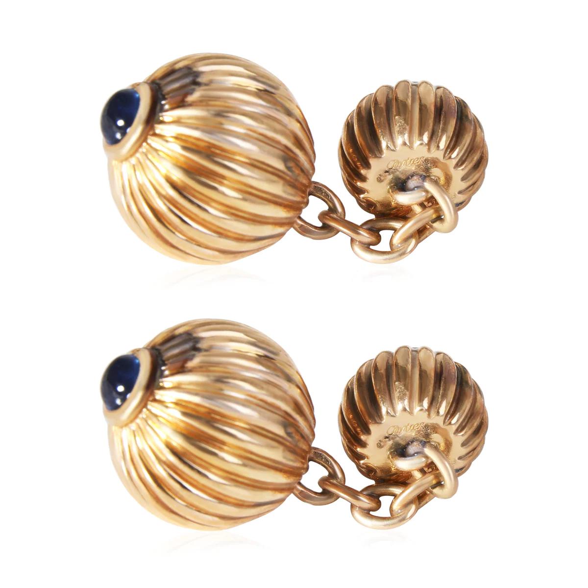 Designer: Cartier

Era: Vintage

Style: Set of Two Cufflinks

Metal: Yellow Gold

Metal Purity: 18K

Stones: Sapphires

Stone Cut: Round Shaped​​​​​​​

Total Item Weight: 13.47 g

Includes: 24 Month Brilliance Jewels Warranty
               