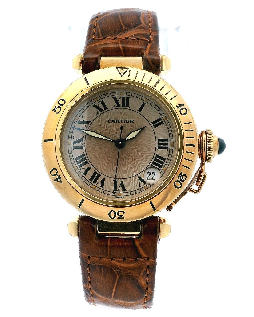 Cartier Pasha W3004856 Watch. 35mm 18k yellow gold case with a stationary bezel. Patina dial with blue steel hands. Magnified date. 18k yellow gold chained crown cover with blue cabochon. Light-Brown leather strap with 18k yellow gold buckle. 