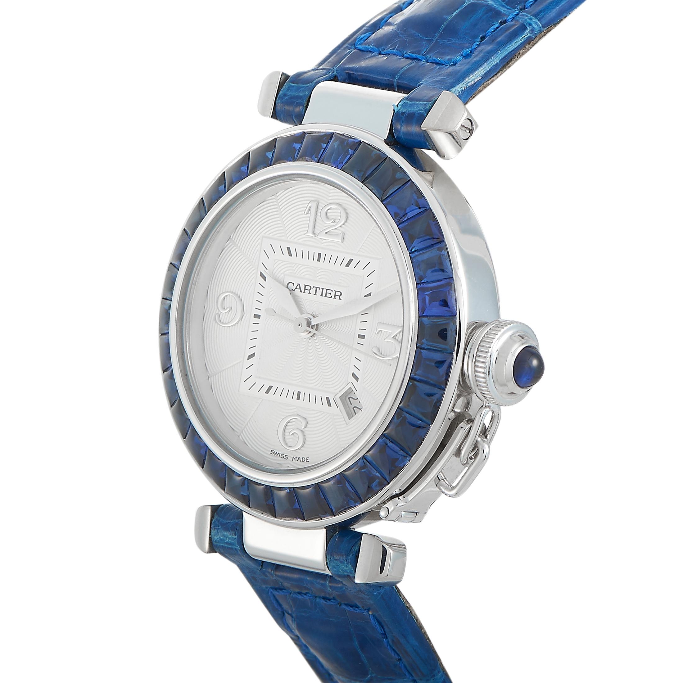 This is the Cartier Pasha, reference number WJ106751.
 
 The watch comes with a water-resistant 18K white gold case that boasts sapphire-set bezel. The case is presented on a blue leather strap fitted with a deployment clasp. This model is powered