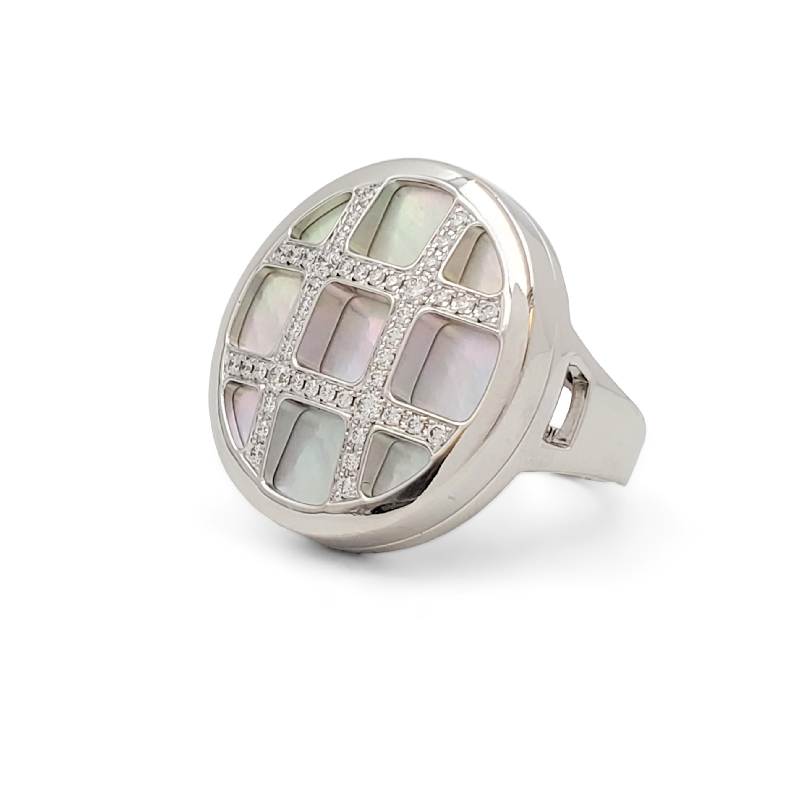 Authentic Cartier 'Pasha' ring crafted in 18 karat white gold designed as a round mother-of-pearl plaque with a lattice overlay set with an estimated 0.56 carats of round brilliant cut diamonds. Signed Cartier, 750, 54, with serial number. The ring