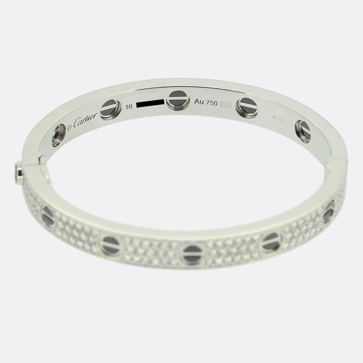Here we have an 18ct white gold diamond bangle from the world renowned luxury jewellery house of Cartier. This bangle forms part of the LOVE collection and features black ceramic set to the iconic screw motifs around the outer edge with 204 round