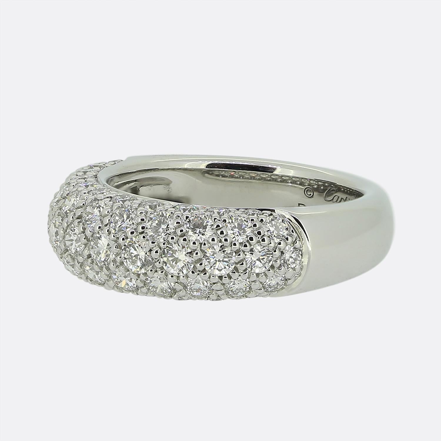 Here we have a timeless diamond ring from the world renowned jewellery house of Cartier. This wonderful piece has been crafted from 18ct white gold and displays four glistening rows of round brilliant cut diamonds collectively pavé set at the face.