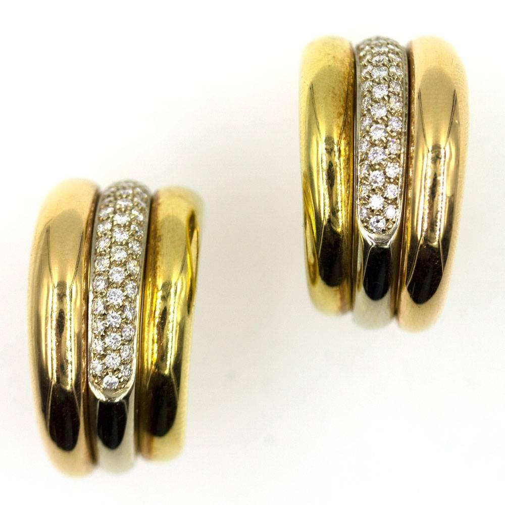 These beautiful Cartier pave diamond hoop earrings, circa 2005,  are fashioned in 18 karat yellow, white, and rose/pink gold. The tricolor designer hoops feature 1.20 carats of high quality round brilliant cut diamonds graded E-F color and VVS