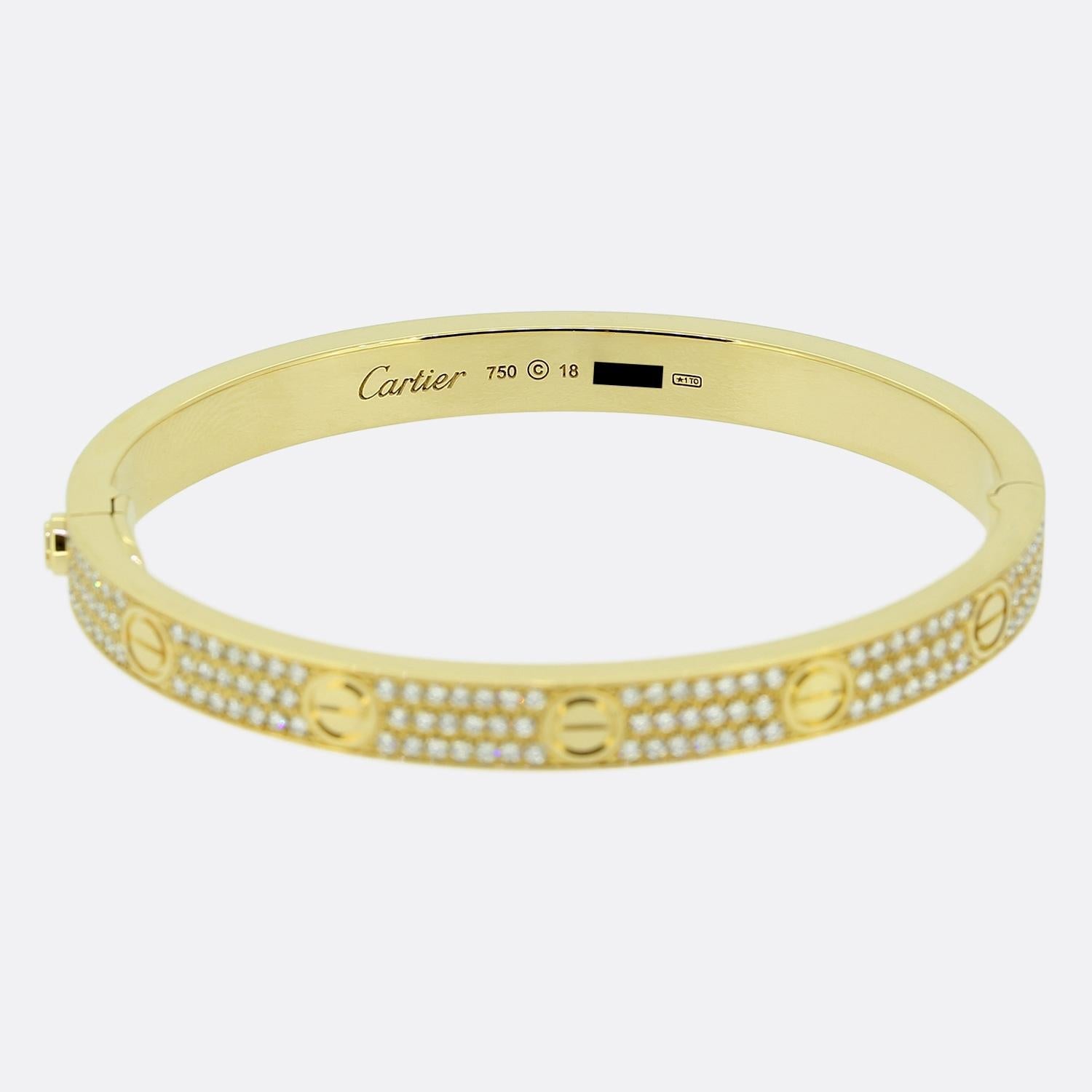 Here we have an 18ct yellow gold bangle from the world renowned luxury jewellery house of Cartier. This bangle forms part of the LOVE collection and features the iconic screw motif around the entire outer edge whilst being interspersed by 204 bright