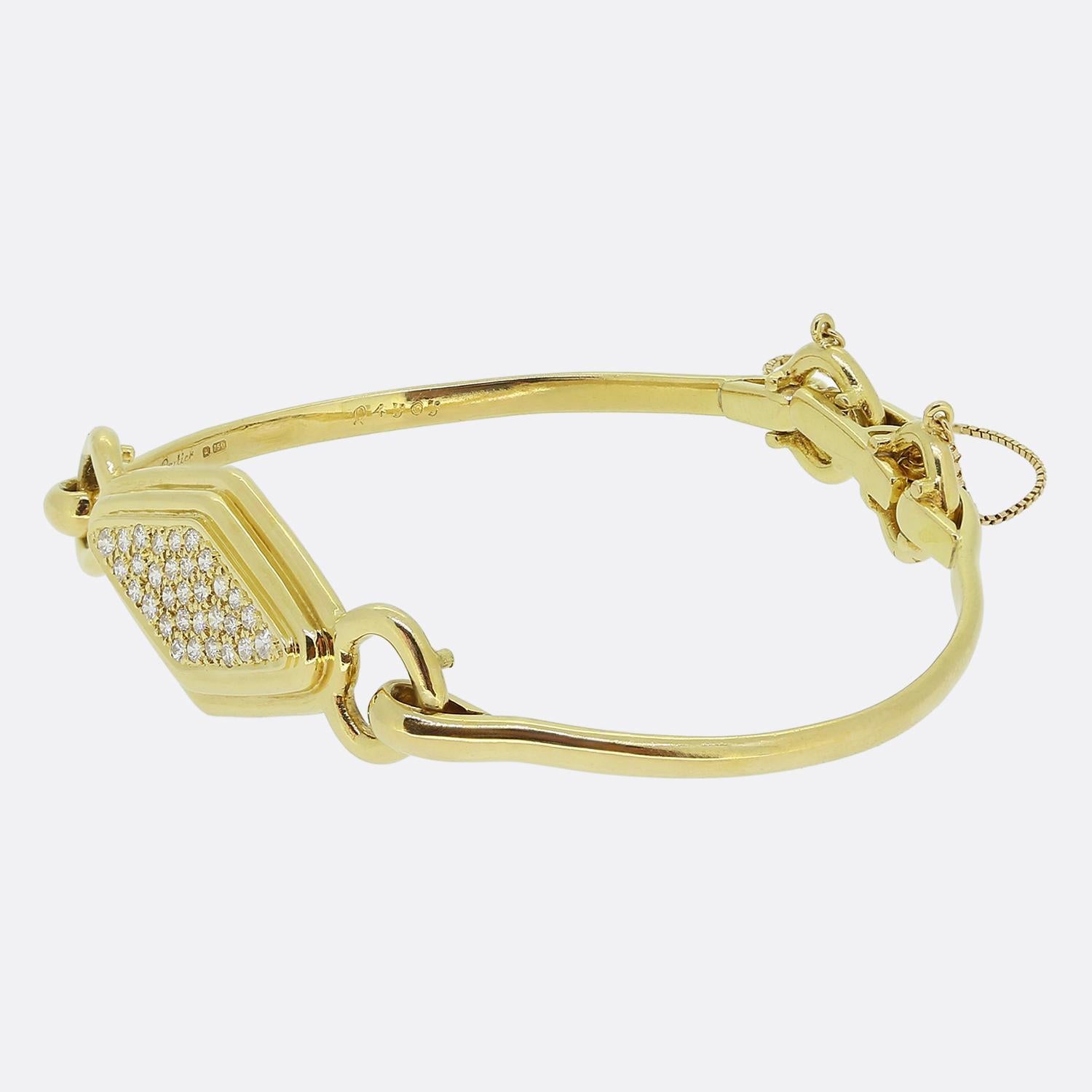 Ecco uno splendido braccialetto della famosa casa di gioielli di lusso Cartier. Questo pezzo vintage presenta un motivo centrale a forma di diamante a più strati, incrostato di diamanti bianchi rotondi a taglio brillante. Le pietre sono