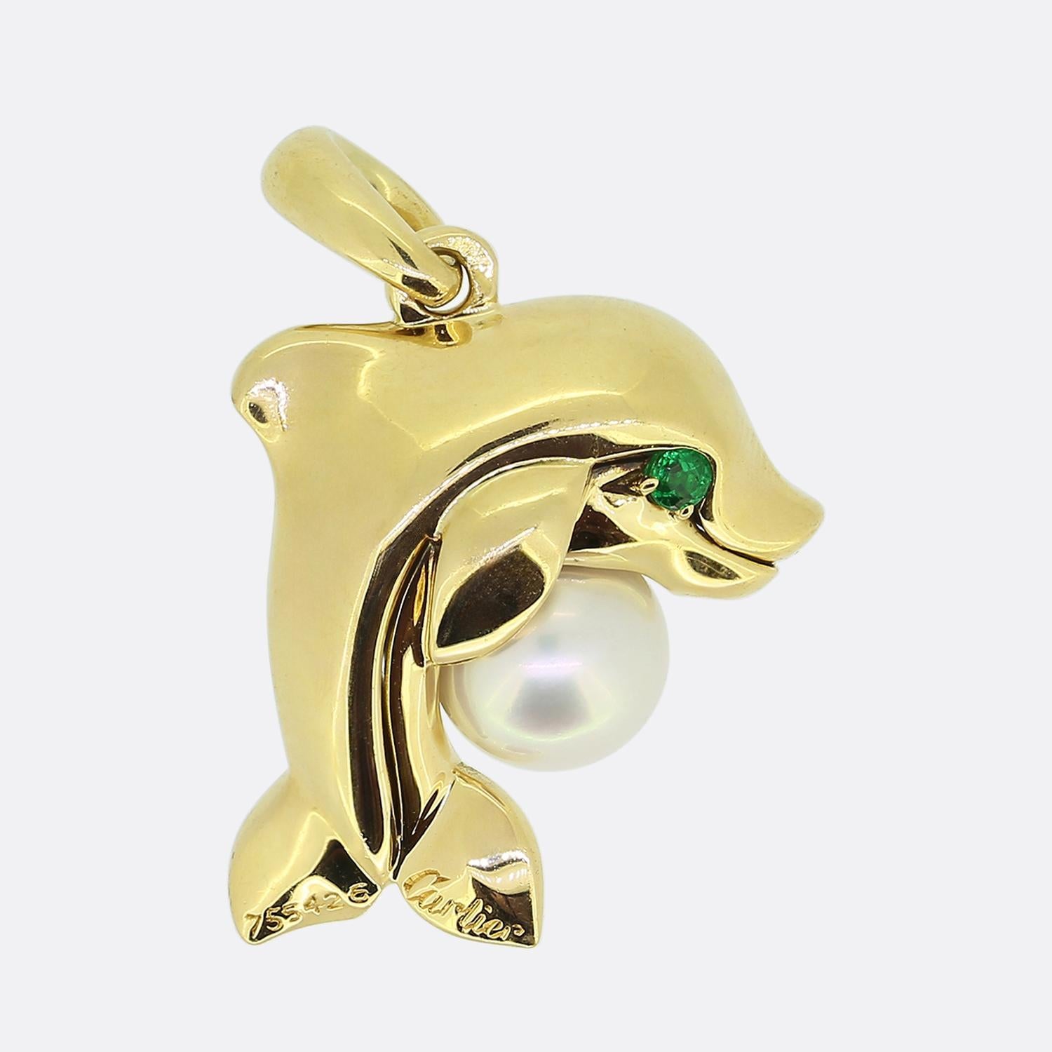 Here we have a charmingly whimsical pendant from the world renowned luxury jewellery house of Cartier. This piece has been crafted from 18ct yellow gold into the shape of a plump dolphin surmounting a round shaped pearl possessing a lovely level of