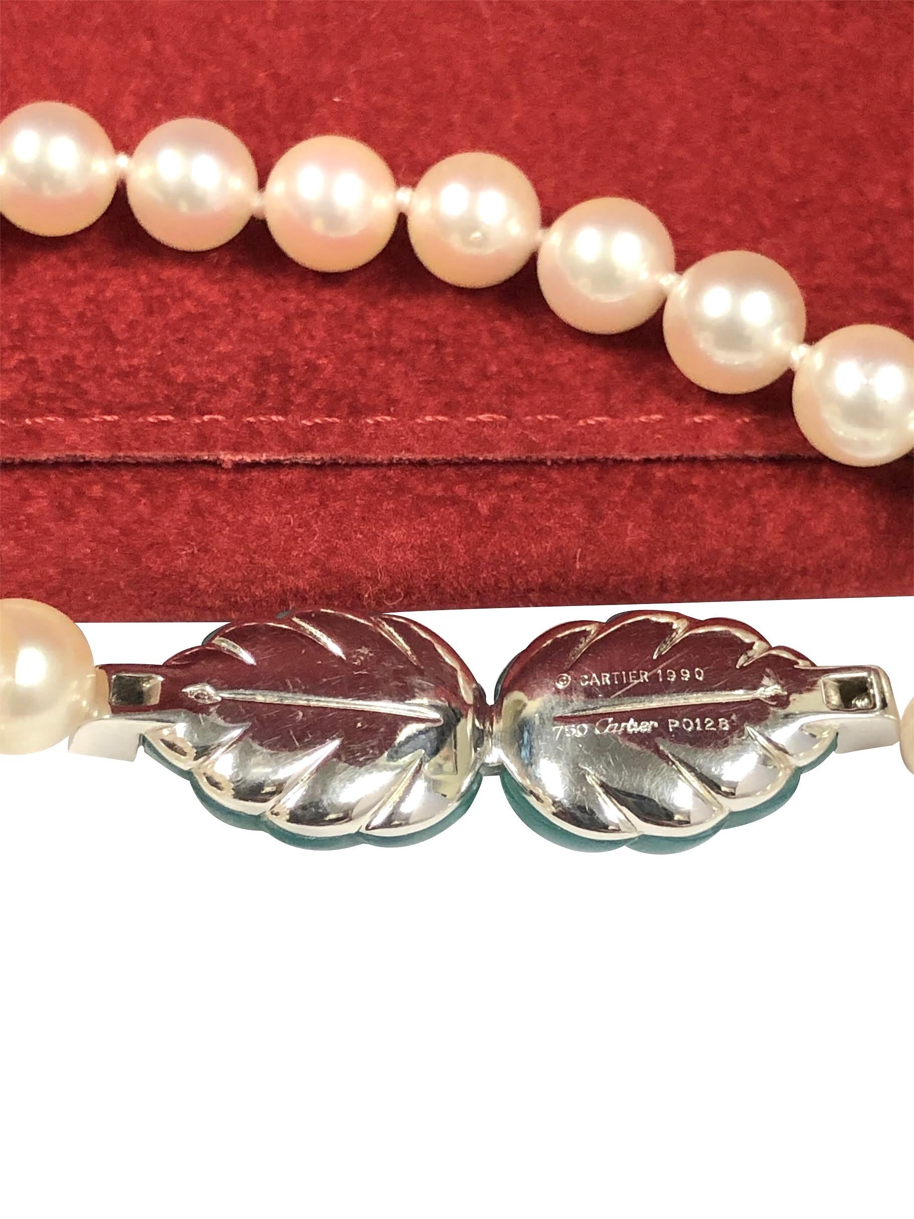 Circa 1990 Cartier Necklace, measuring 16 inches in length and comprised of 6.5 M.M. very Fine color and Luster Akoya  Cultured Pearls. The center section measures 1 1/4 X 1/2 inch and is White Gold with hand carved Green Chrysoprase Leaves and