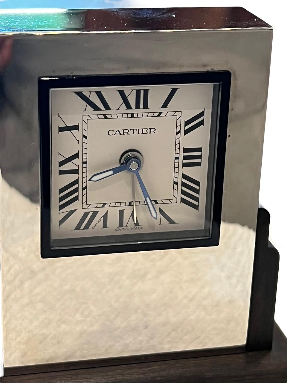 Exuding the timeless elegance of the Art Deco era, this exquisite table clock hails from the illustrious house of CARTIER. With a reputation for luxury and sophistication, this clock embodies the pinnacle of craftsmanship and design. A testament to