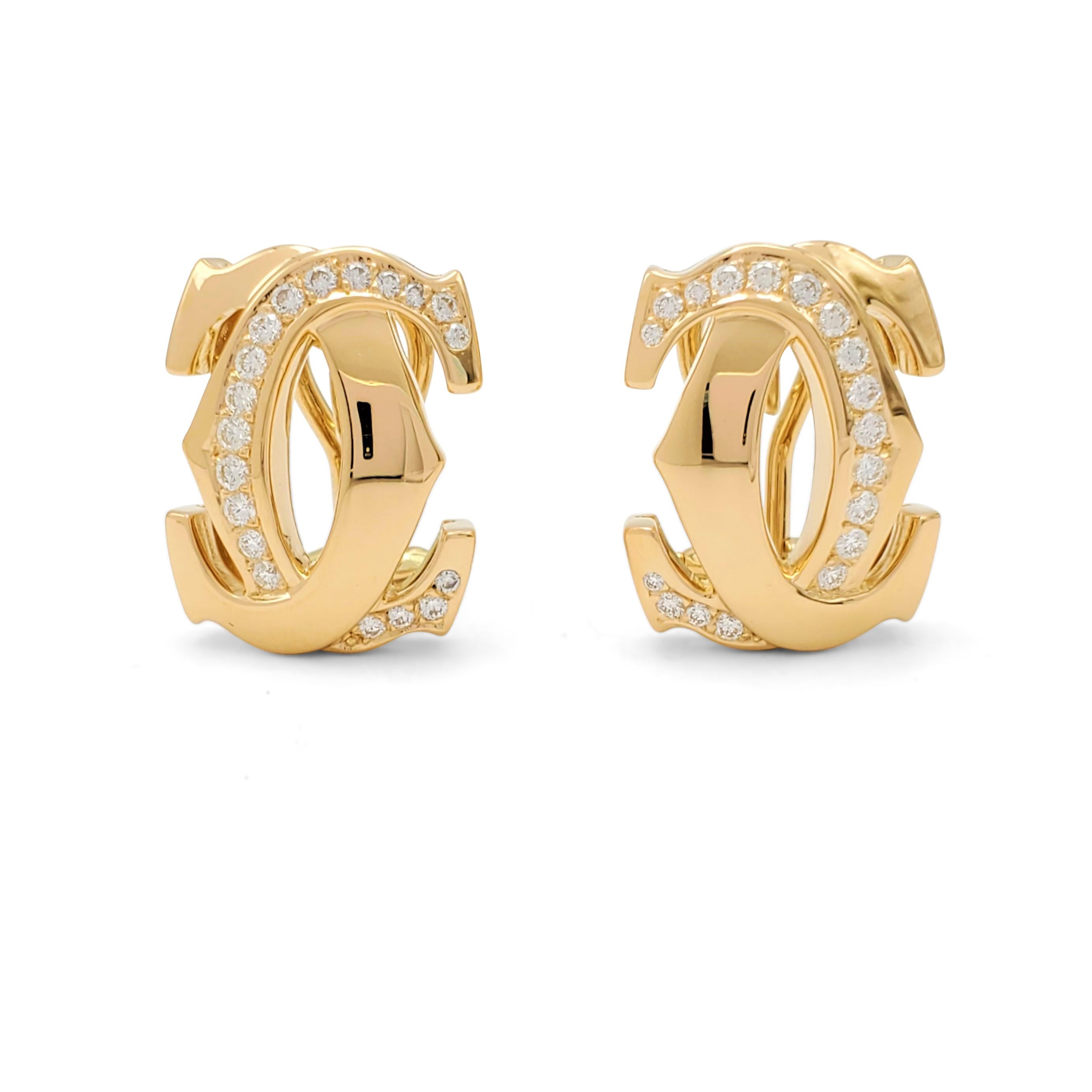 Authentic Cartier 'Penelope' earrings crafted in 18 karat yellow gold center on the iconic interlocking Cartier double-C motif. The earrings are set with an estimated 0.55 carats total weight of round brilliant cut diamonds (E-F color, VS clarity).