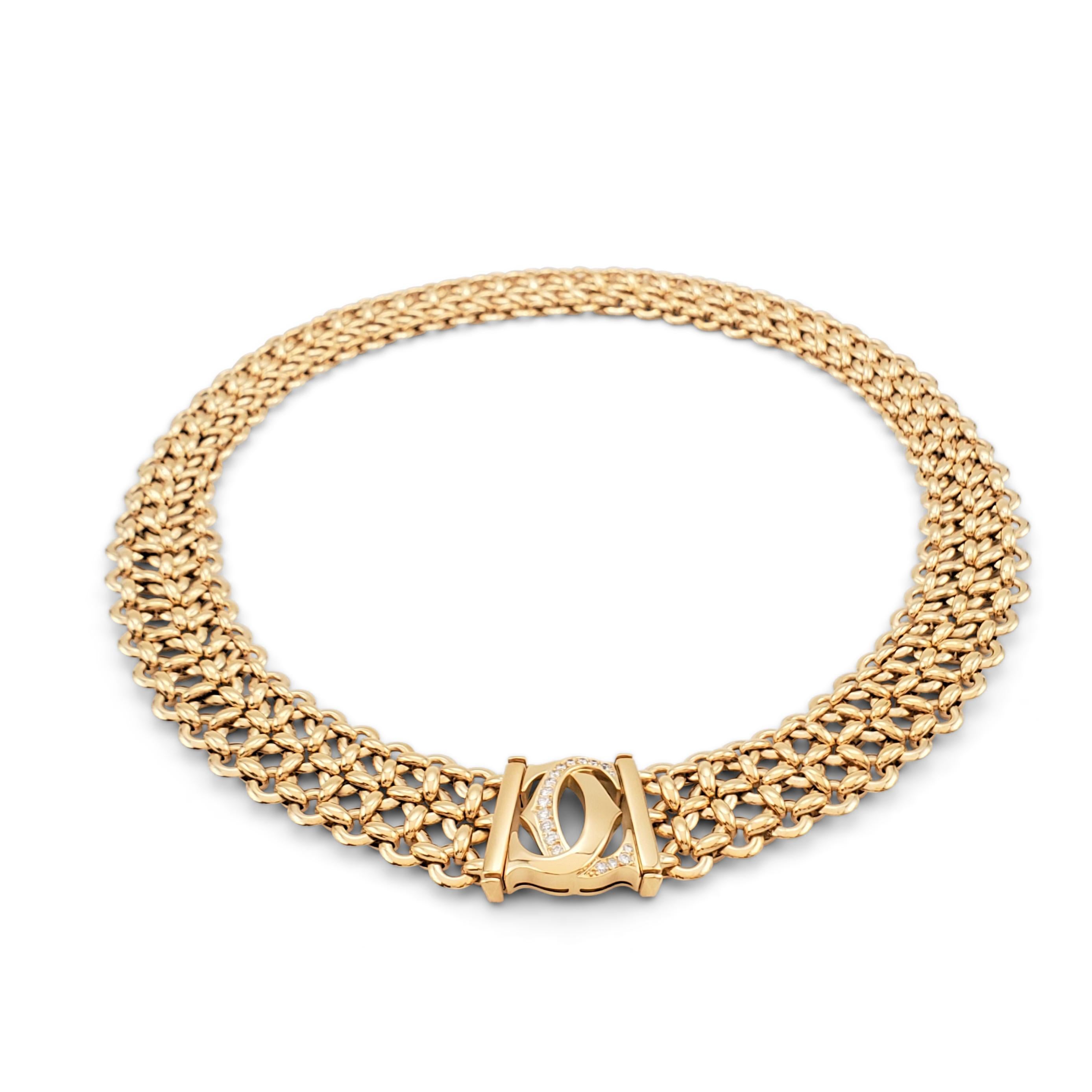 Authentic Cartier 'Penelope' necklace comprised of three-rows of 18 karat yellow gold links centering on the Cartier double-C motif which is set with an estimated 0.30 carats of round brilliant cut diamonds (E-F color, VS clarity). Signed Cartier,
