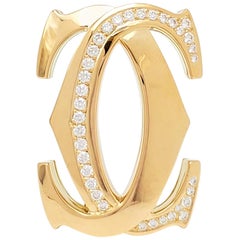 Cartier Pin 'Penelope' aus Gelbgold mit Doppel-K und Diamanten