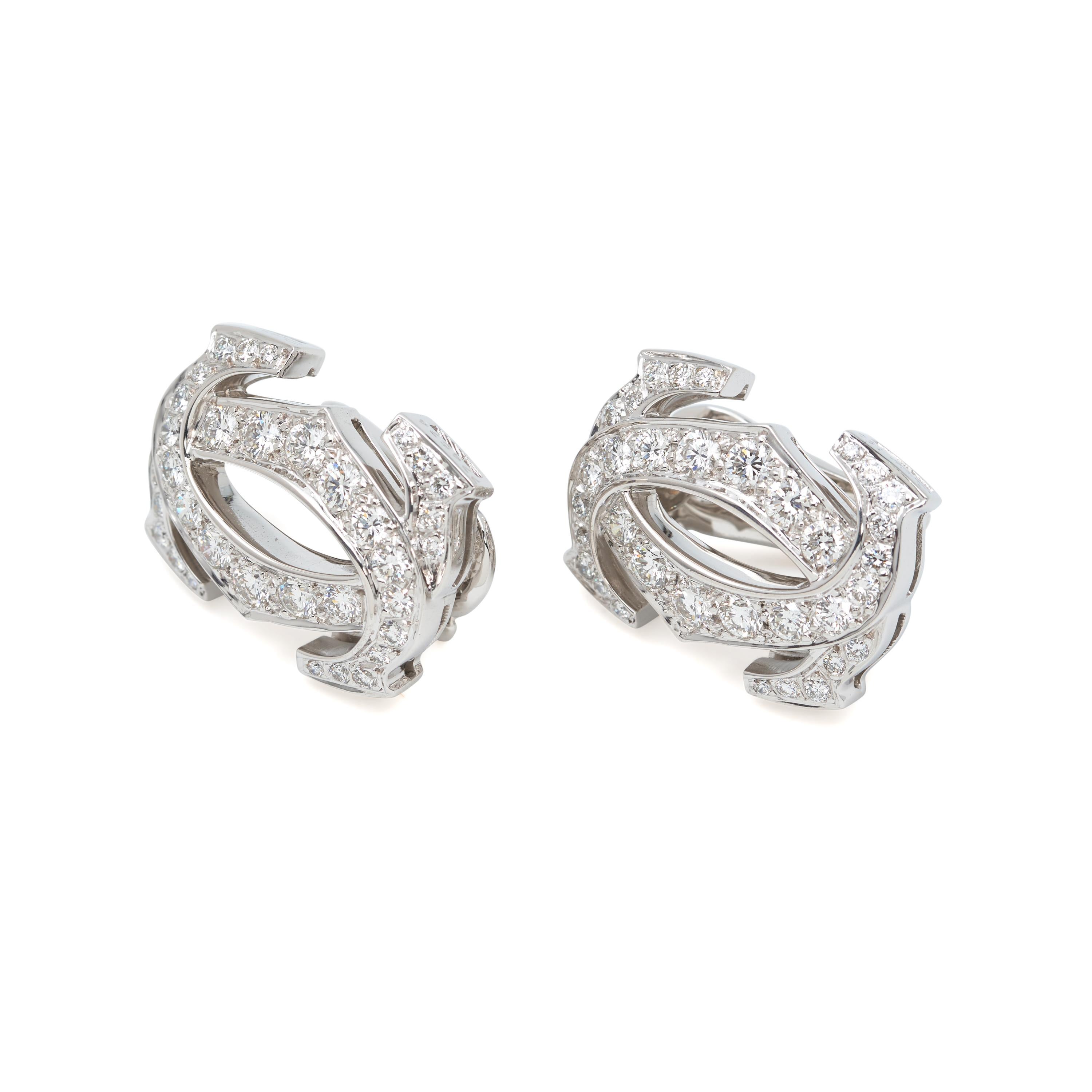 Authentic Cartier Penelope earclips crafted in 18k white gold and set with an estimated 2 carats of high-quality round brilliant cut diamonds. The earrings measure 21mm in length and 16mm in width with clip backs for non-pierced ears.  Signed