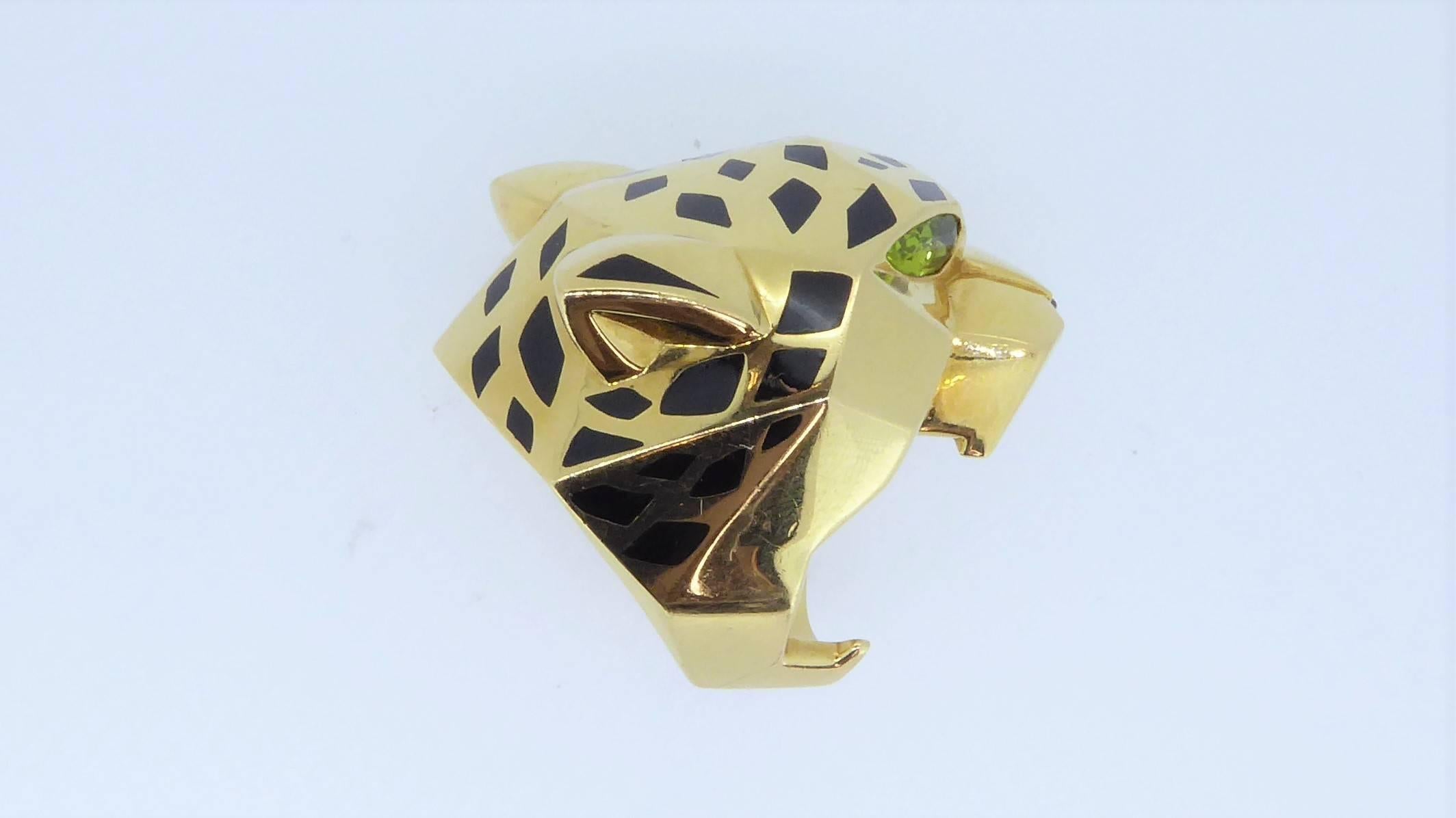 A Cartier Peridot, Onyx, Enamel and 18 Carat Yellow Gold Panthere Ring. Size L