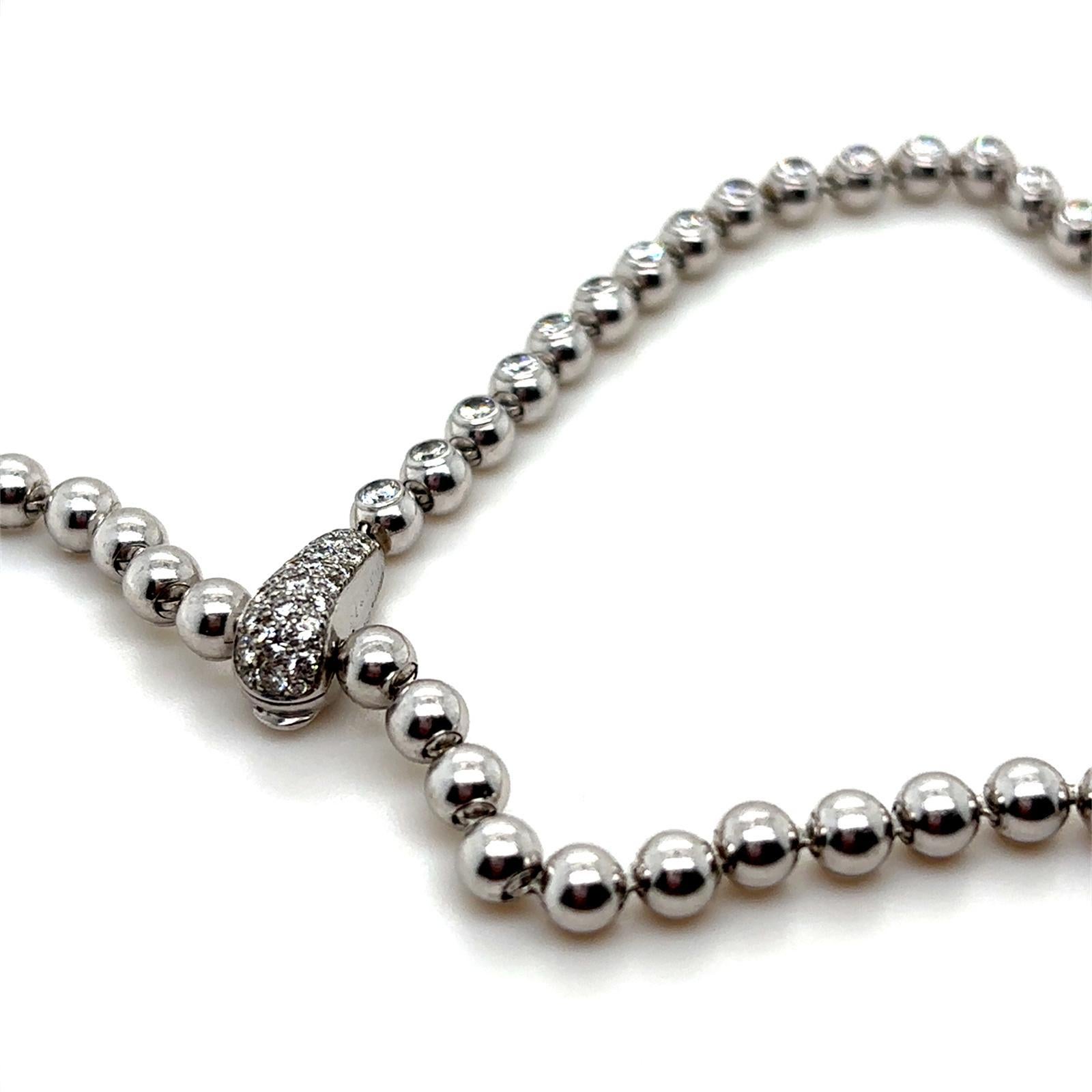 A Cartier Perles de Diamants 18 karat white gold diamond necklace, circa 2000

This vintage necklace from Cartier's 'Perles de Diamants' collection is designed as a series of plain polished white gold circular beads each set to its centre with a