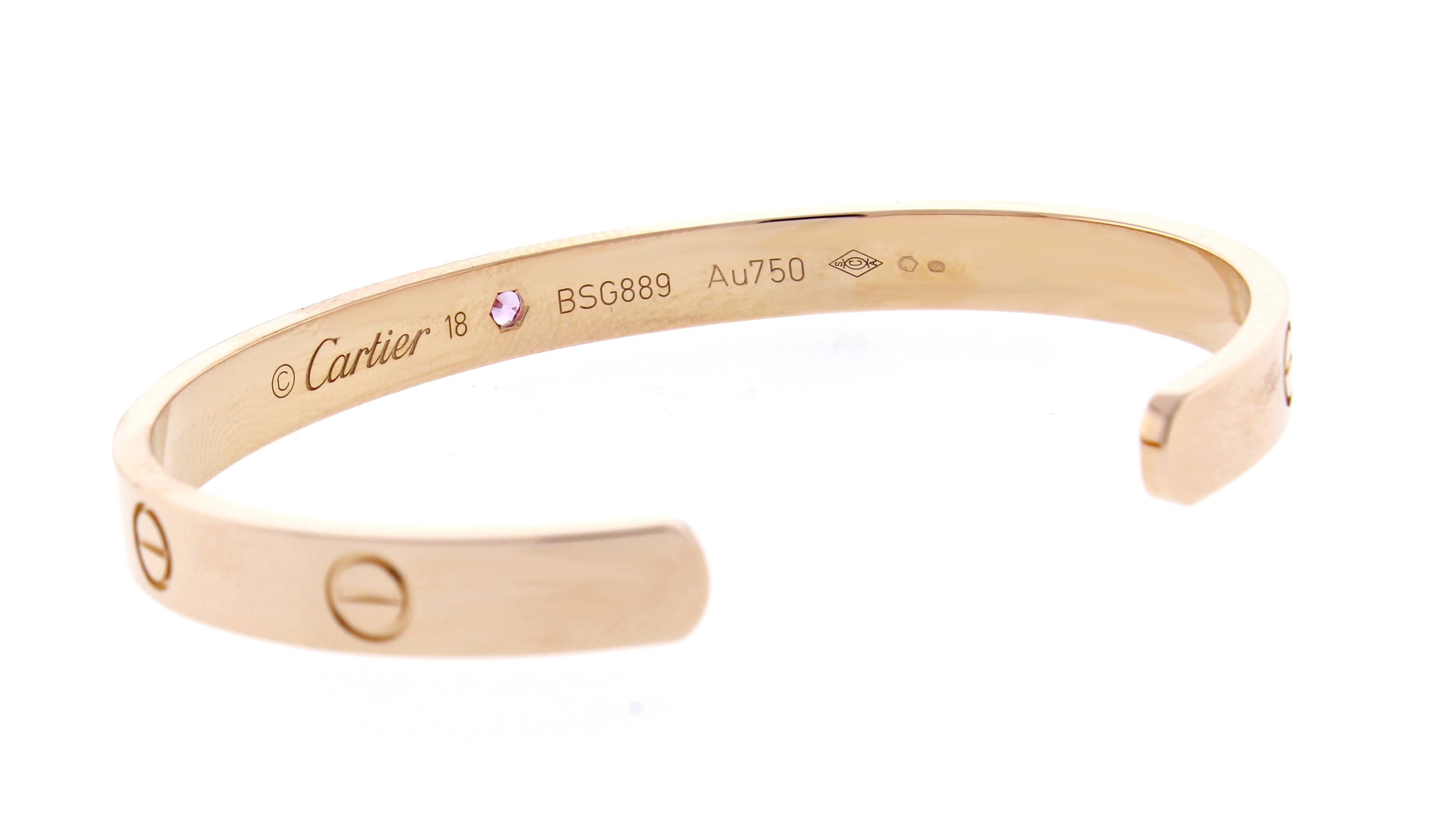 18 karat pink gold Cartier Love cuff bracelet set with a single pink sapphire.  The love bracelet remains an iconic symbol of love that transcends convention. Size 18, 