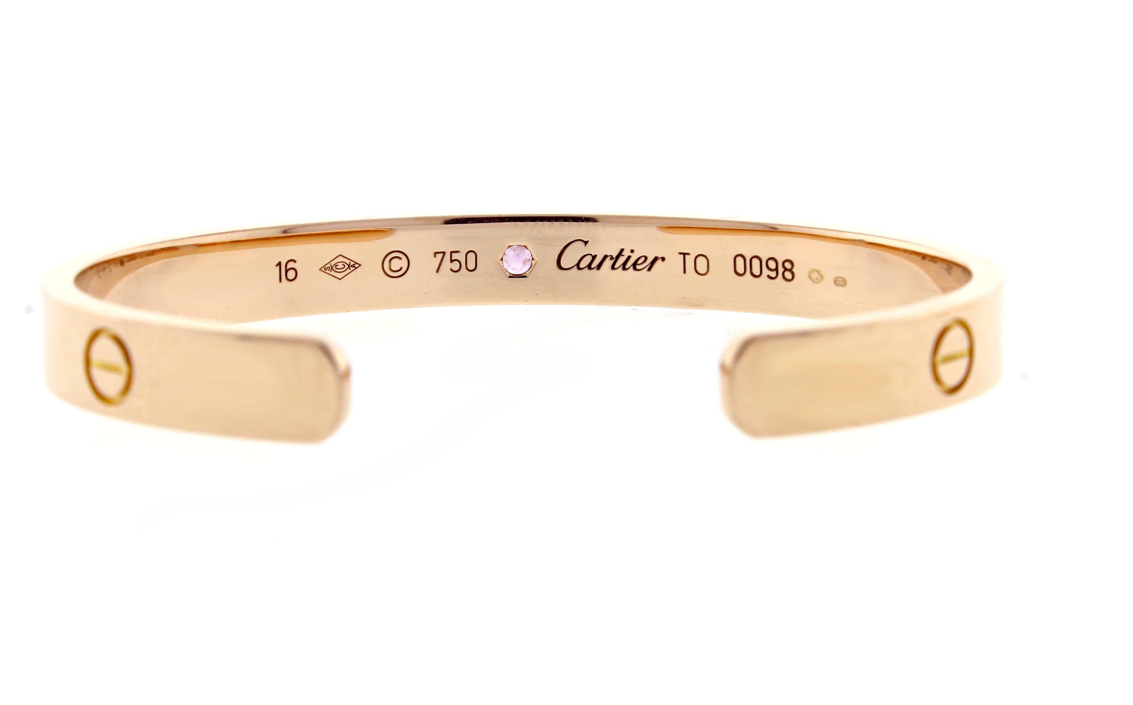18 karat pink gold Cartier Love cuff bracelet set with a single pink sapphire. The love bracelet remains an iconic symbol of love that transcends convention. Size 16, as new in original box