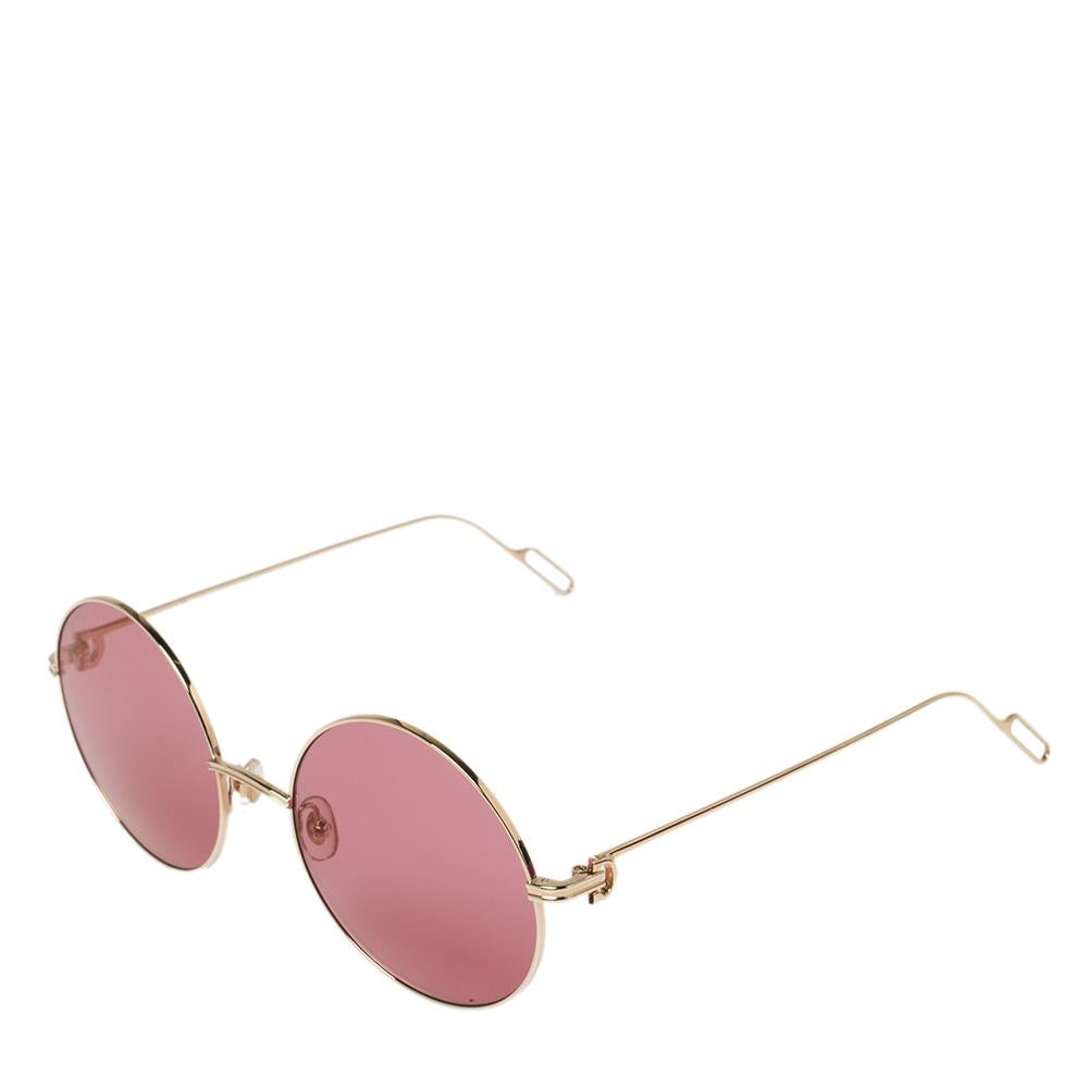 Designed with a luxurious aesthetic, this pair of Cartier sunglasses exudes class. Their gold-tone frames are coupled with pink lenses and slender temples.

Includes: Original Dust Cloth, Info Booklet, Original Case, Original Pouch, Original Box