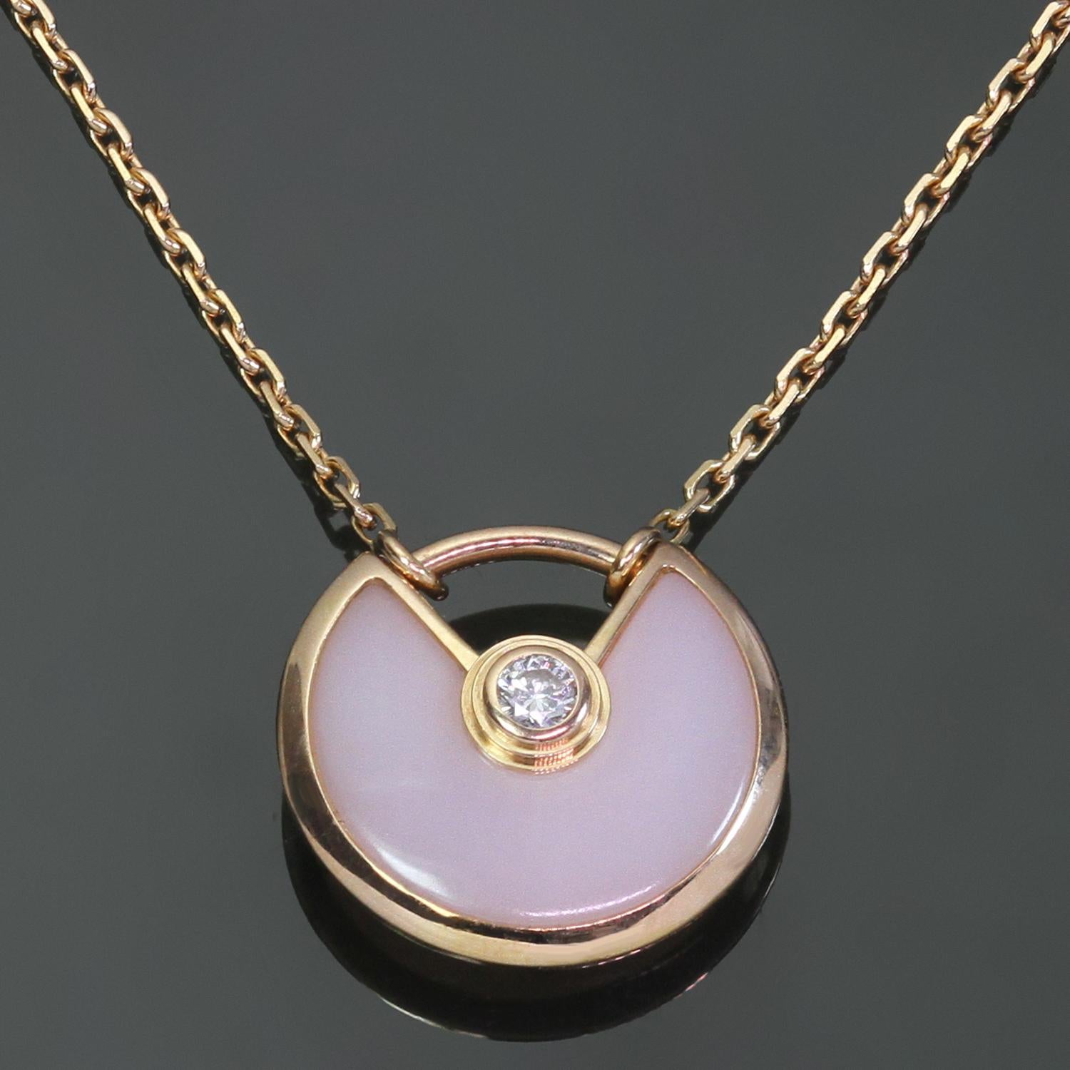 This gorgeous Cartier 18k rose gold necklace features a round amulette pendant set with pink opal and accented with a round brilliant-cut D-F VVS1-VVS2 diamond weighing an estimated 0.02 carats. Made in France circa 2010s. Measurements: 0.47