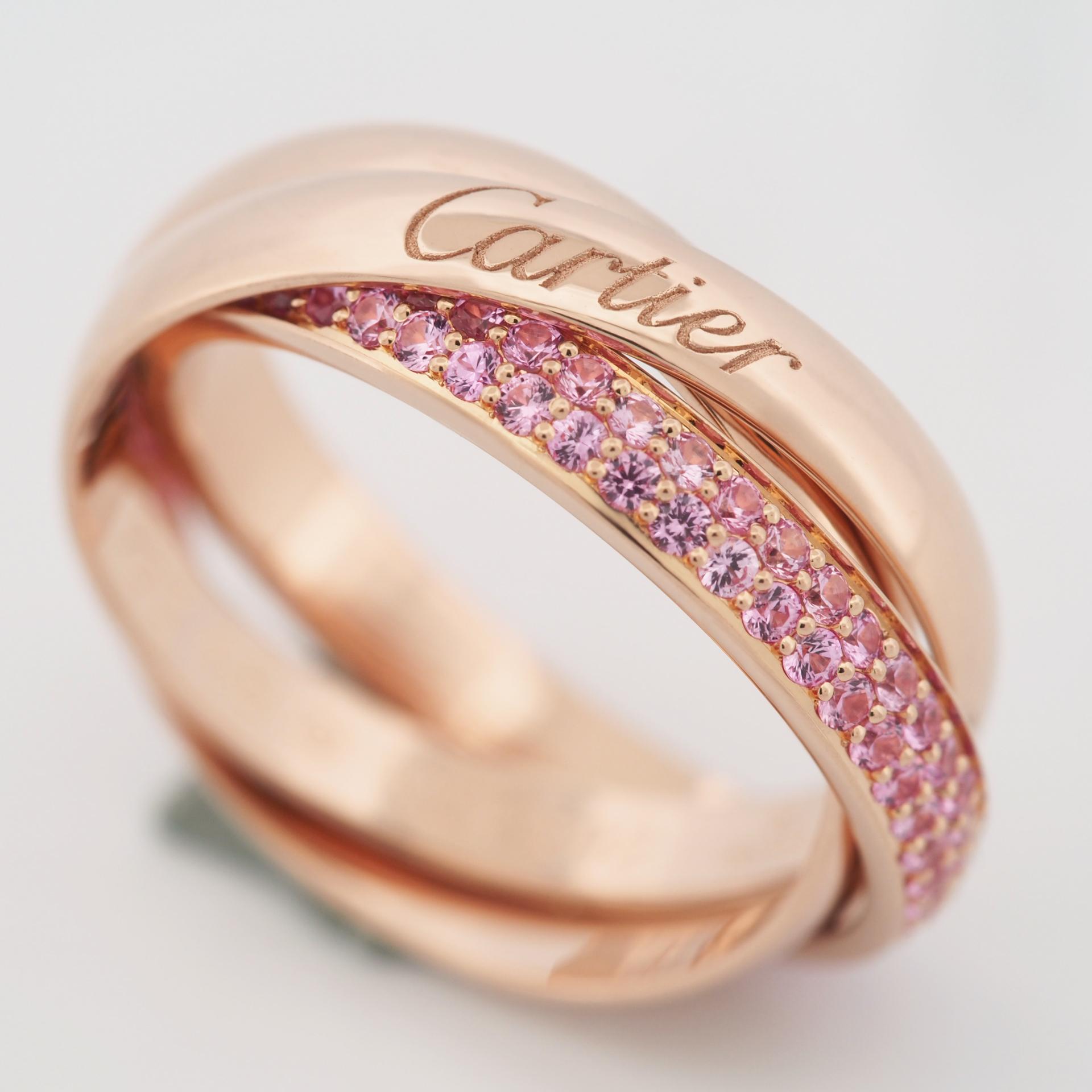Item: Authentic Cartier Trinity Ring 
Stones: Pink Sapphire
Metal: 18K Rose Gold
Ring Size: 48 US SIZE 4.5 UK SIZE I 1/4
Internal Diameter:  15.30 mm
Measurement:  2.7 mm (each band)
Weight:  4.9 Grams
Condition: Used (repolished)
Retail Price: