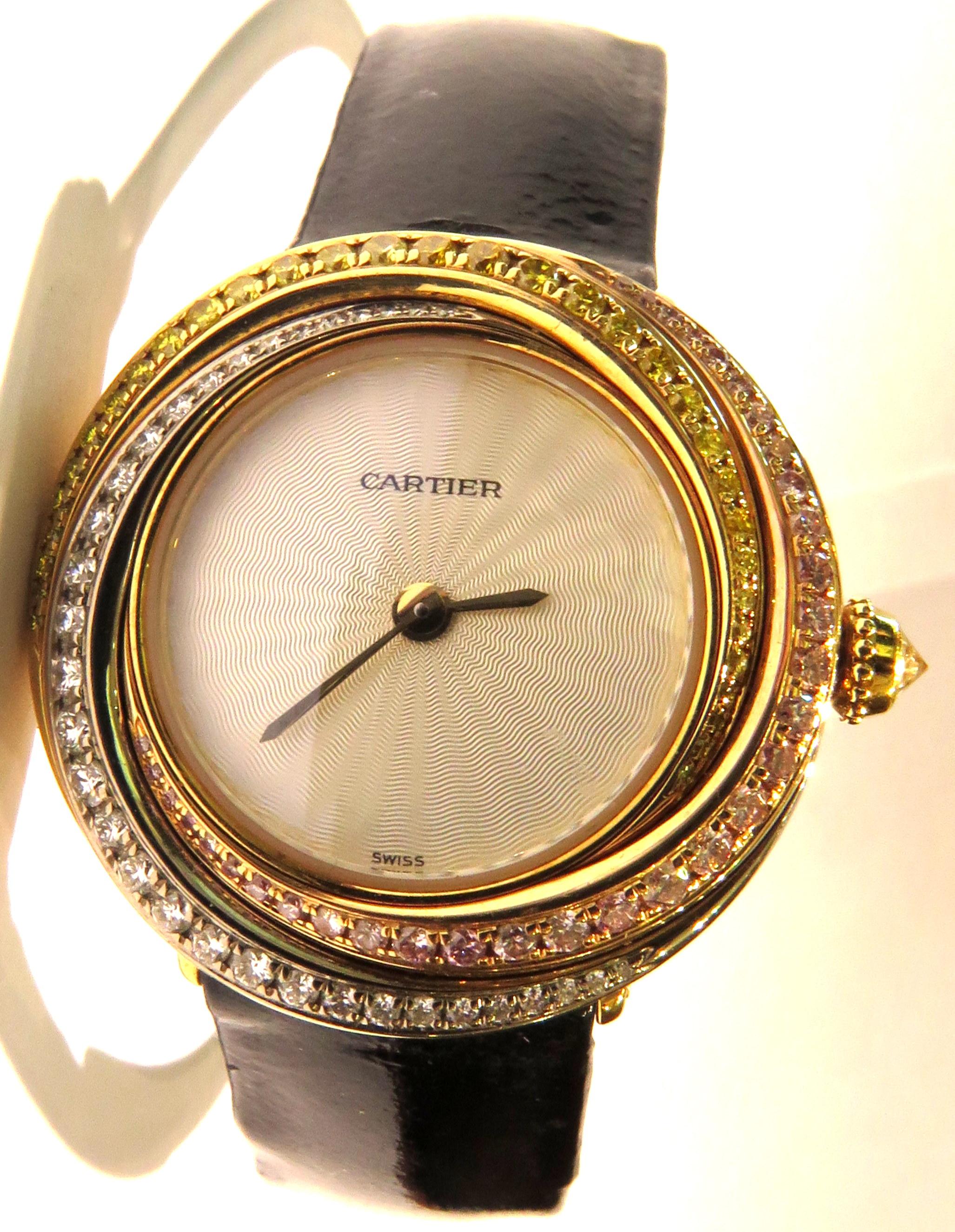 This classic Cartier Trinity quartz watch is chic & sporty! It's set in 18k yellow white & rose gold with fancy color pink yellow and white diamonds. This watch has the original band & deployment buckle. This watch is in very good pre owned