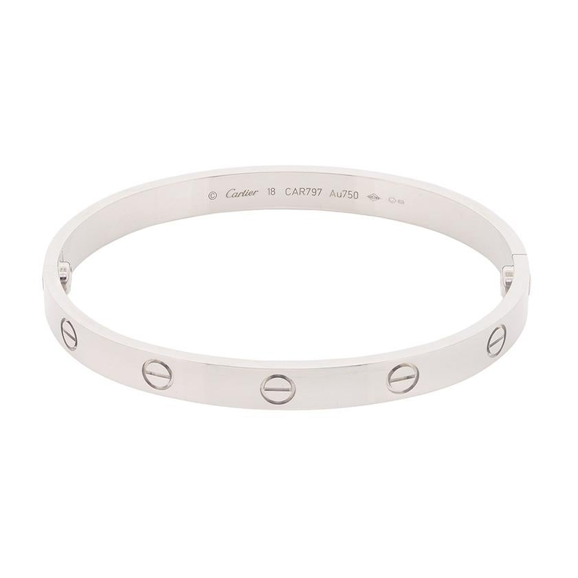An original and classic Cartier Love Bangle. It is the non-diamond design withe the screw pattern. The bangle is a size 17, made in 18 carat white gold and is a more modern piece as the screws are not removable. It comes with the original Cartier