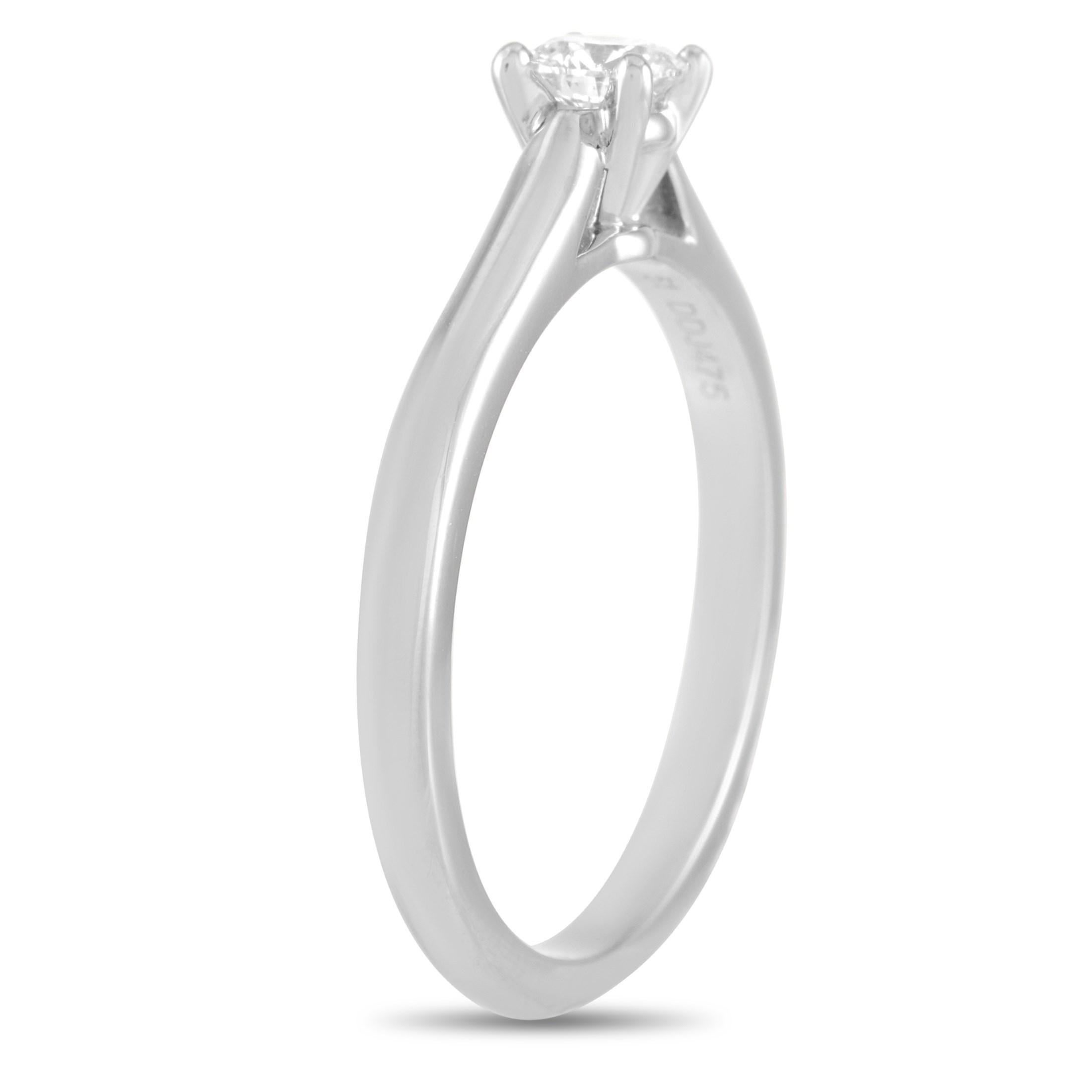 Subtle and gorgeous, the Cartier Platinum 0.23 ct Diamond Engagement Ring features a delicate band and a 0.23 carat round brilliant diamond with VVS1 clarity and F color grade. This classy and dainty engagement ring promises a silhouette that's easy