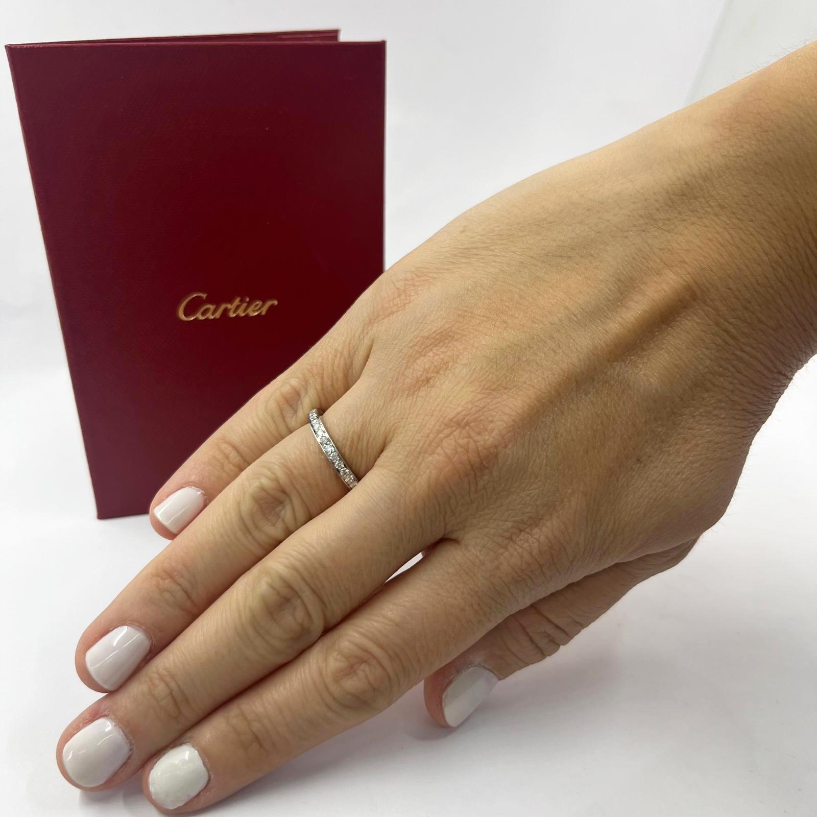 Cartier platinum eternity band featuring 34 round brilliant cut diamonds of VS+ clarity and G+ color totaling 0.68 carats. Prong setting with walled edges. Finger size 5.5. Includes Cartier certificate. $5,250 MSRP.