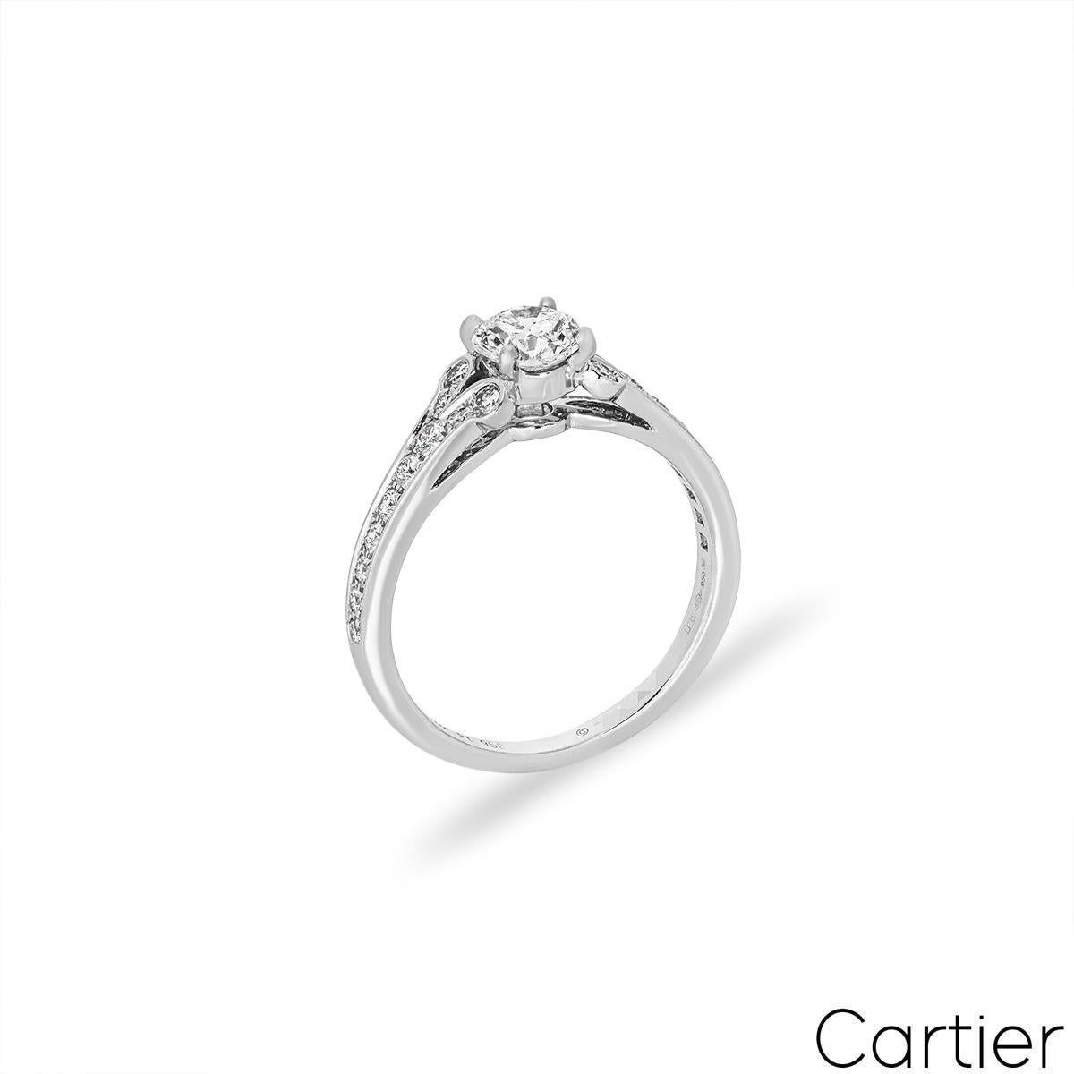 A graceful platinum diamond ring by Cartier from the Ballerine Solitaire collection. The engagement ring features a round brilliant cut diamond set to the centre in a four prong mount weighing 0.71ct, G colour and VVS2 clarity. The ring tapers down