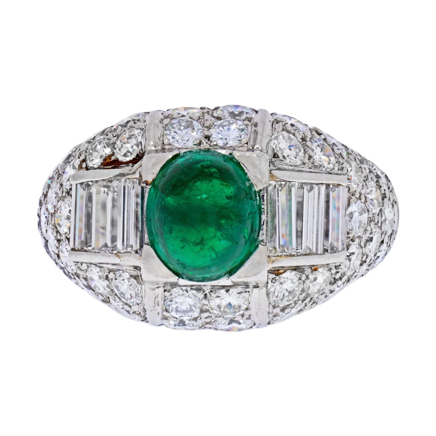 A beautiful platinum ring by Cartier from 1960's featuring cabochon cut green emerald and diaonds of mixed cuts. 
Delicate enough for everyday wear. The center emerald does show some wear to the gem however not very visisble to the naked eye and