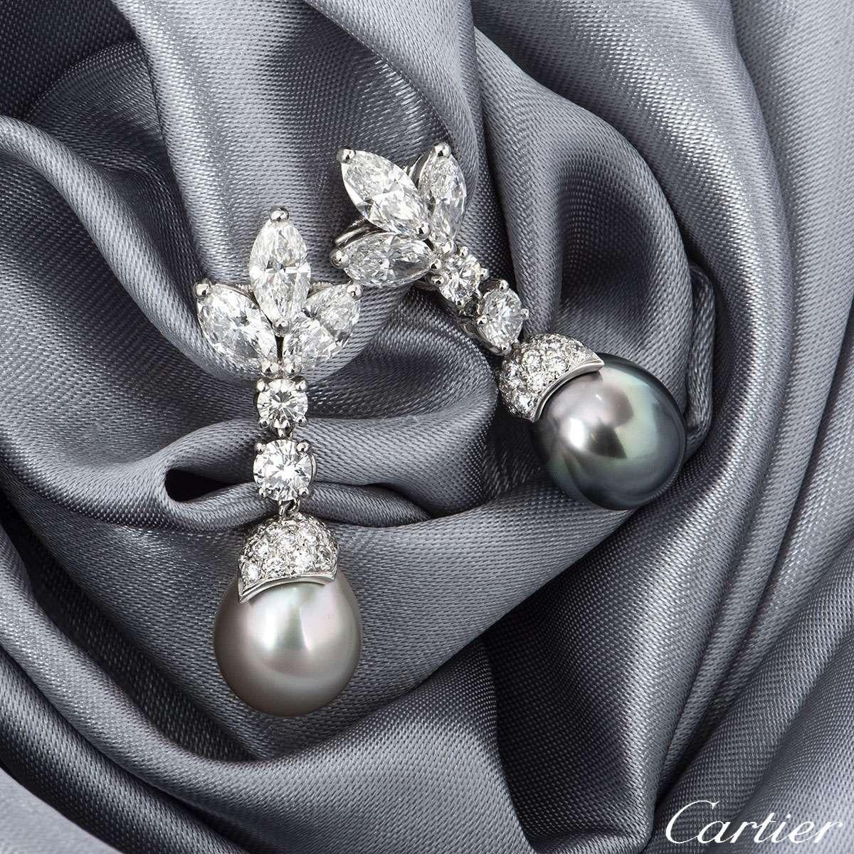 An exquisite pair of Cartier diamond and pearl earrings in platinum from the Cartier de Lune collection. Each earring features a leaf design made up of 3 marquise cut diamonds, with two subsequent round brilliant cut diamonds beneath. Suspended from