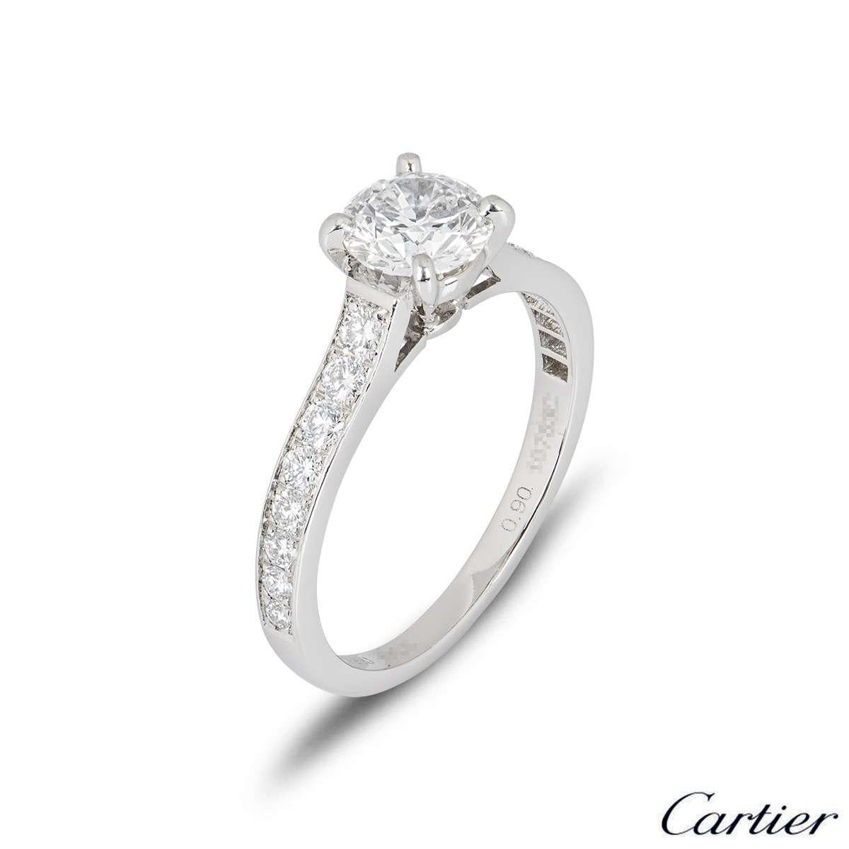 A stunning platinum Cartier diamond engagement ring from the 1895 solitaire collection. The ring comprises of a round brilliant cut diamond in a four claw setting with a weight of 0.90ct, E colour and VS2 clarity. There are 16 round brilliant cut