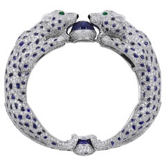 CARTIER Platinum, Diamond and Sapphire Two Panther Head Bangle