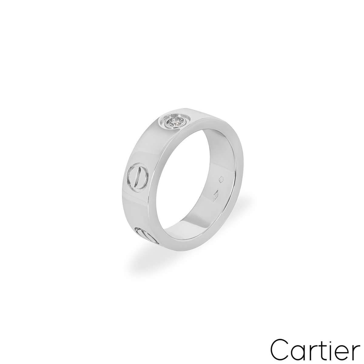 A Cartier diamond ring in platinum from the Love collection. The ring comprises of the iconic Cartier screws and a single round brilliant cut diamond set in the centre. Measuring 5.5mm in width, the ring is a size UK L - EU 51 and has a gross weight