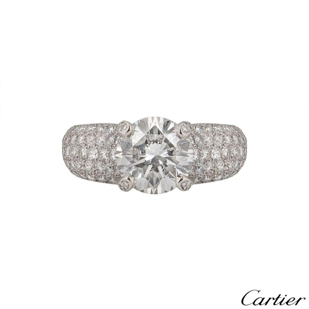 A stunning platinum diamond ring by Cartier from the Luna collection. The ring comprises of a round brilliant cut diamond in a claw setting with a total weight of 2.24ct, F colour and VVS1 clarity with pave round brilliant cut diamonds partially set