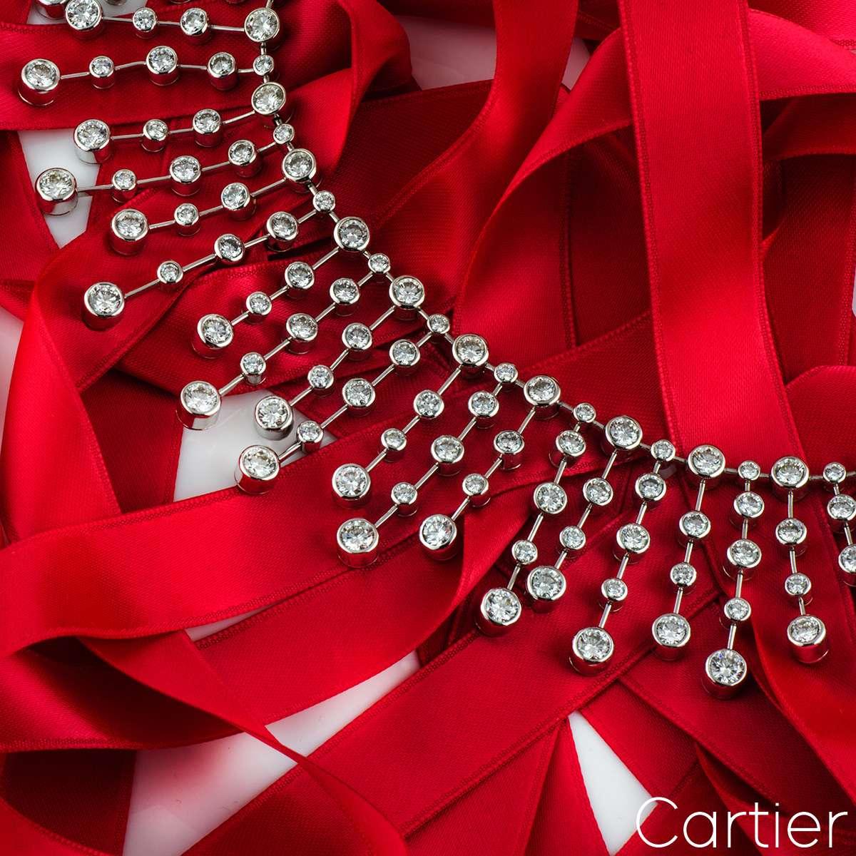 A luxurious platinum Cartier diamond necklace. The necklace comprises of a choker style with 68 platinum collet strands with 306 round brilliant cut diamonds each set in a rubover setting. The strands alternate in length along with the placement of